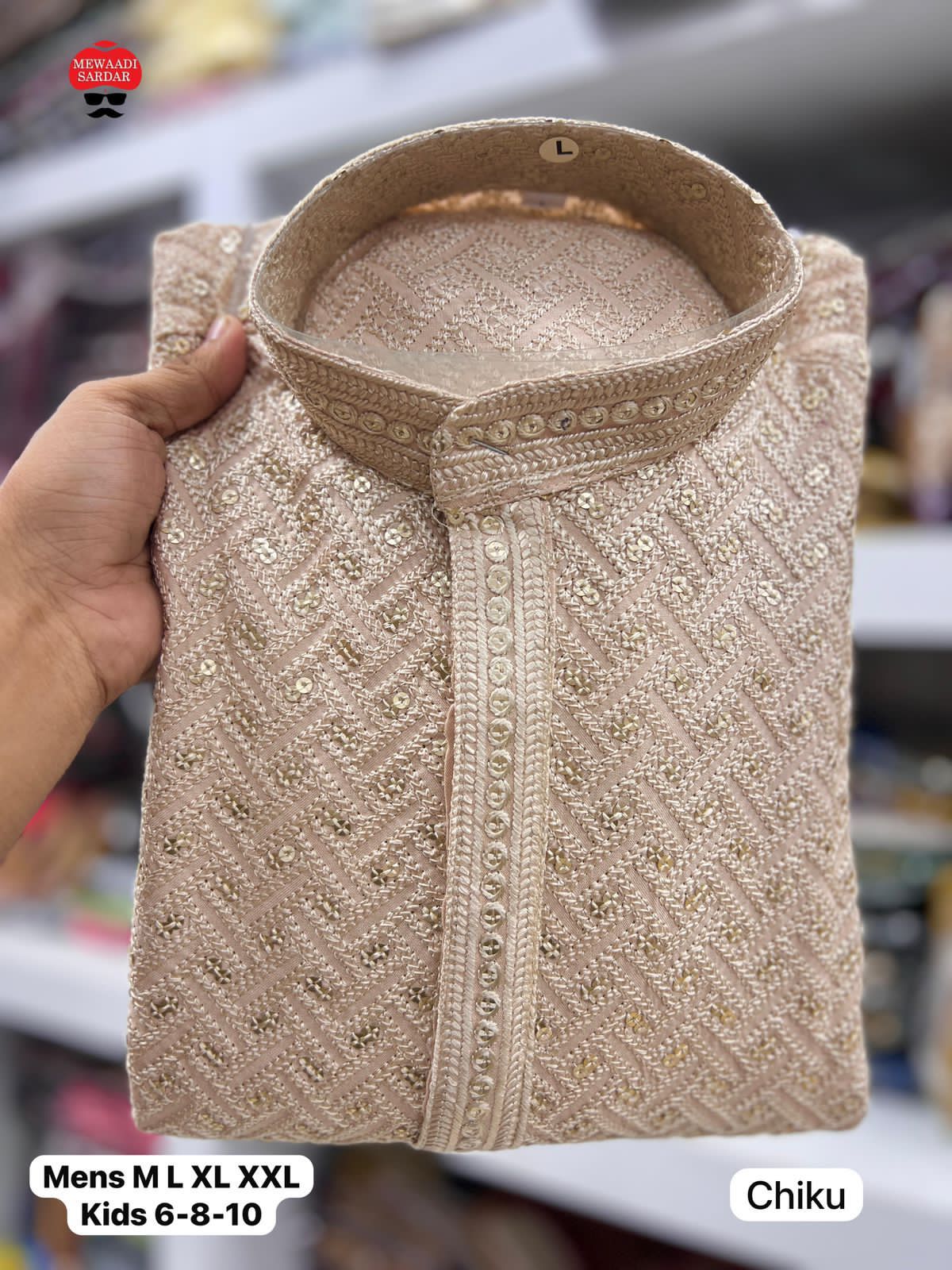 Chiku embroidered shirt held by a hand with branding.