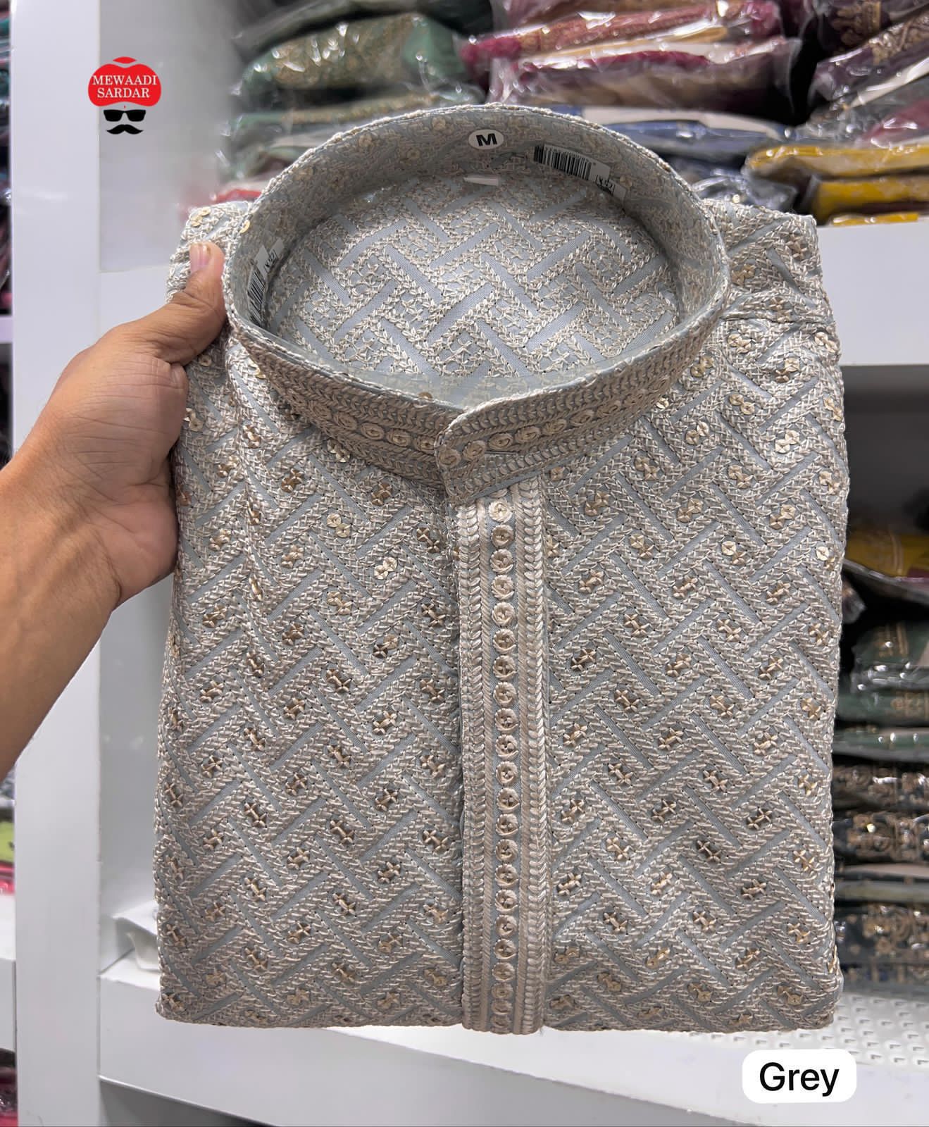 Gray patterned fabric item labeled  with a blurred background.