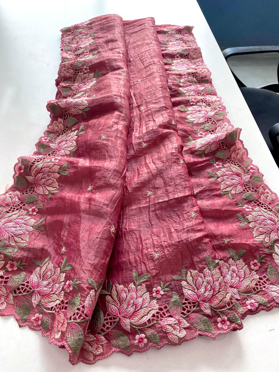 Pink fabric with floral embroidery