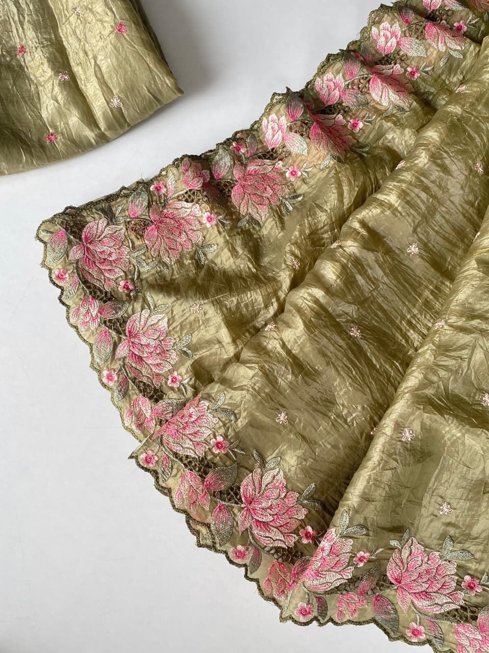 Green fabric with floral embroidery