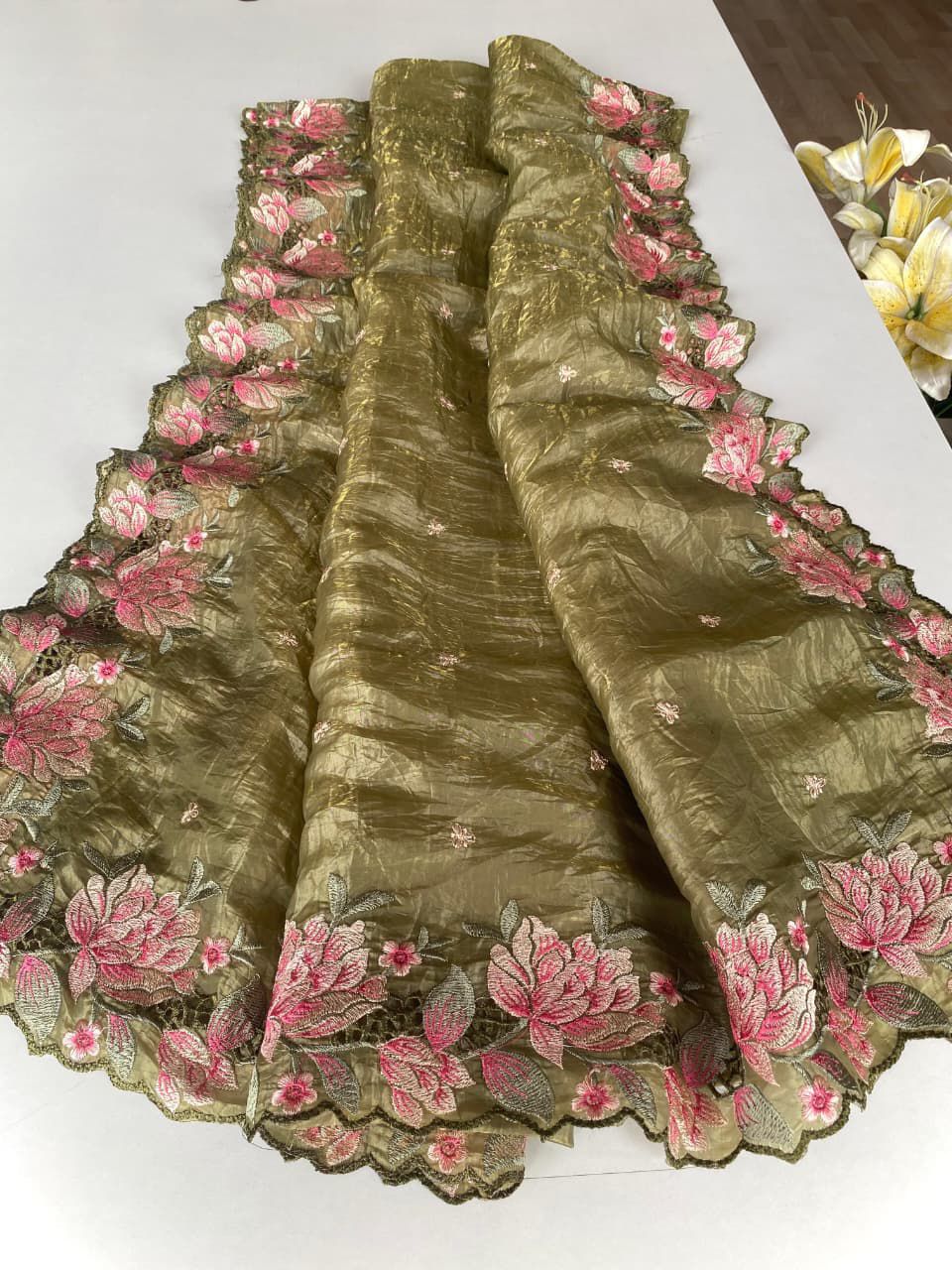 Green fabric with floral embroidery