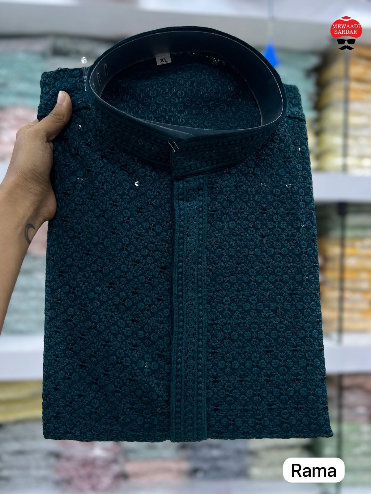 Rama green textured shirt held by a hand with blurred background