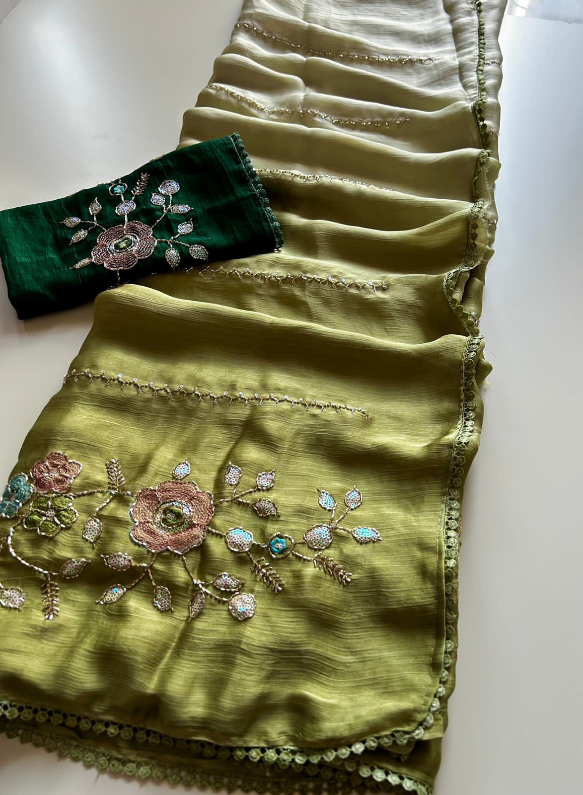 Olive Green embroidered fabric with a white background