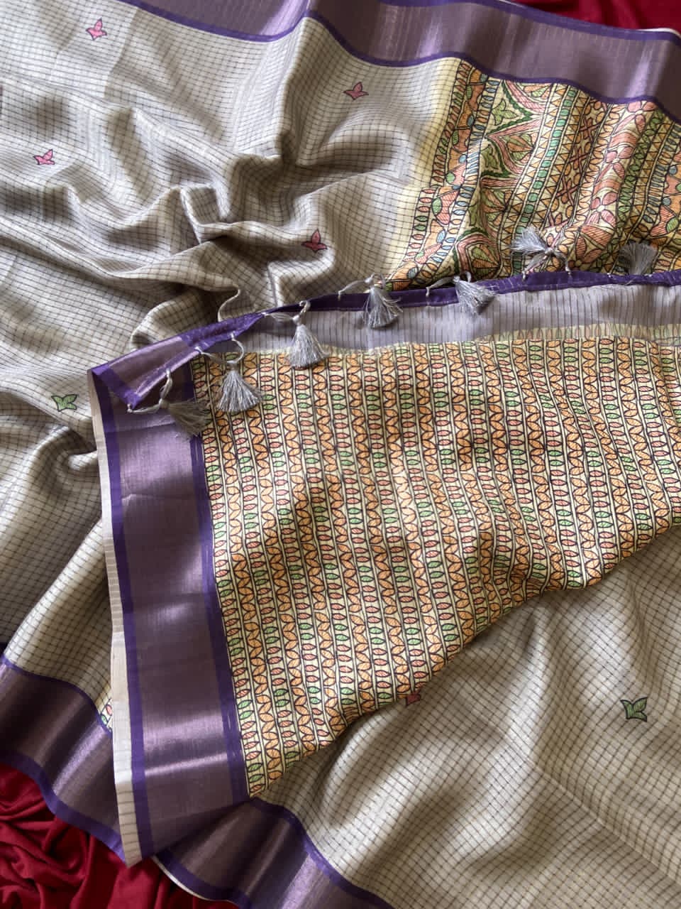 Gray Saree with intricate patterns and a border on a neutral background