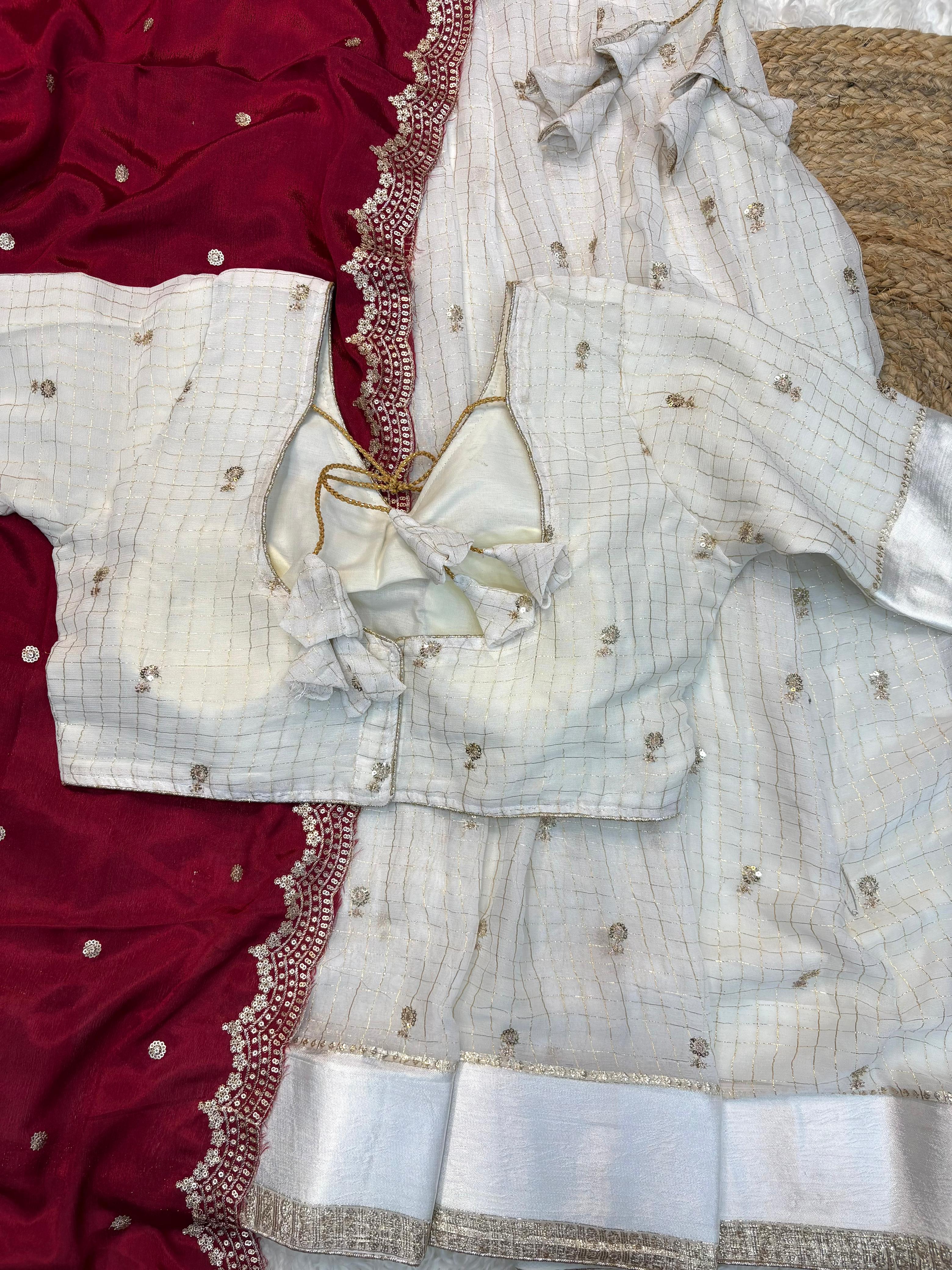 White embroidered fabric with maroon border on a texture surface