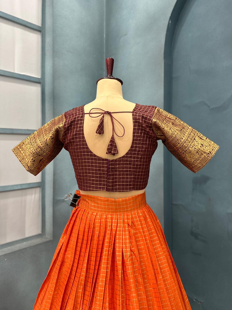 Brown blouse with gold sleeves and orange skirt
