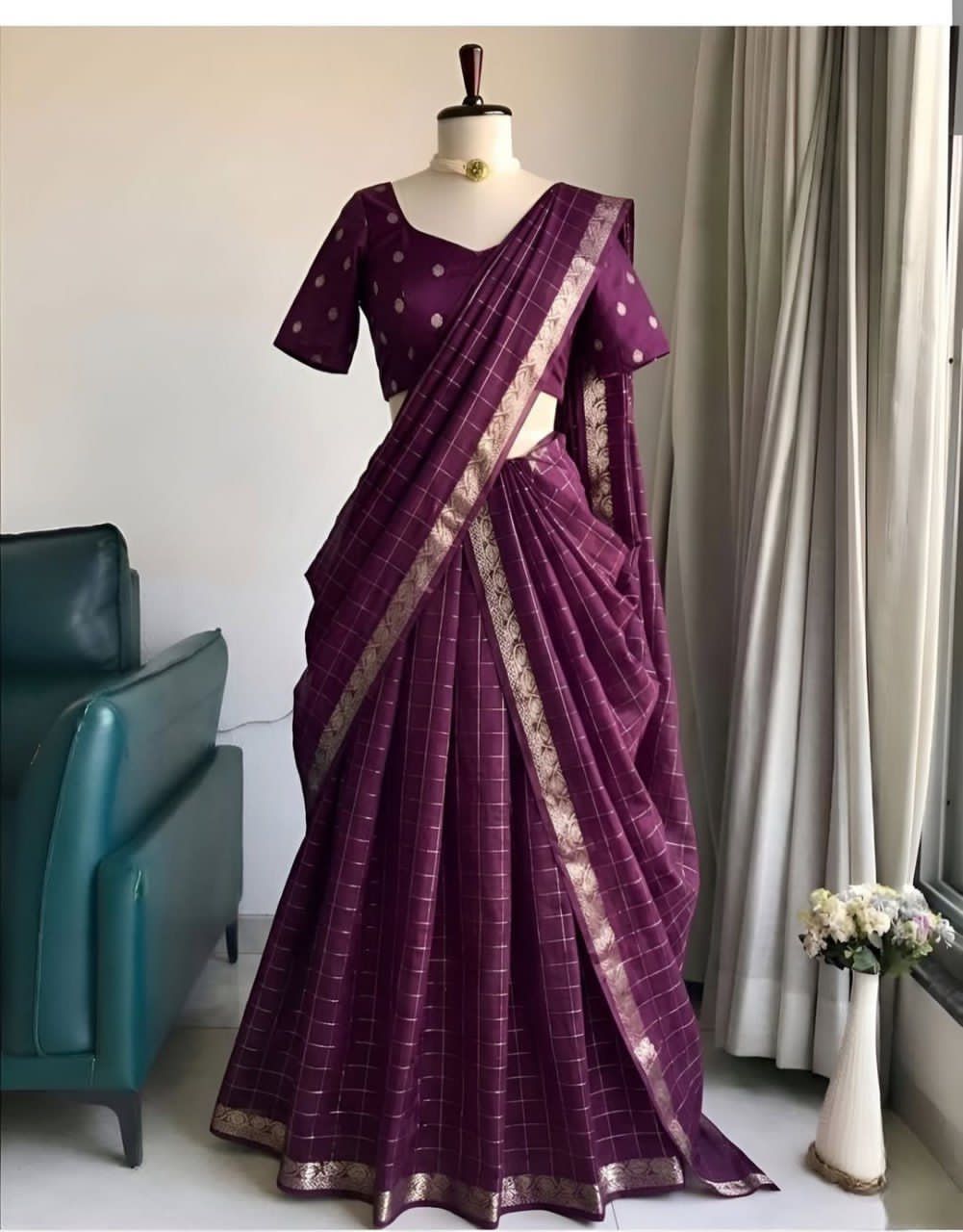 Wine saree with gold border on a mannequin against a neutral background