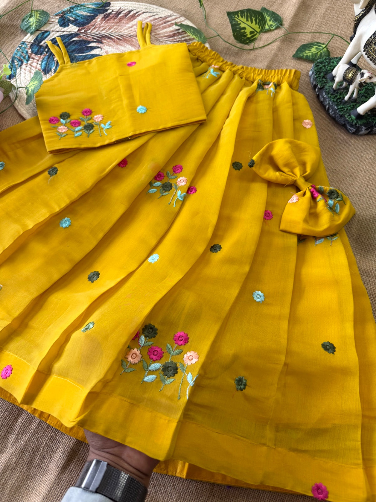 Mustard Yellow outfit with floral embroidery on a patterned surface
