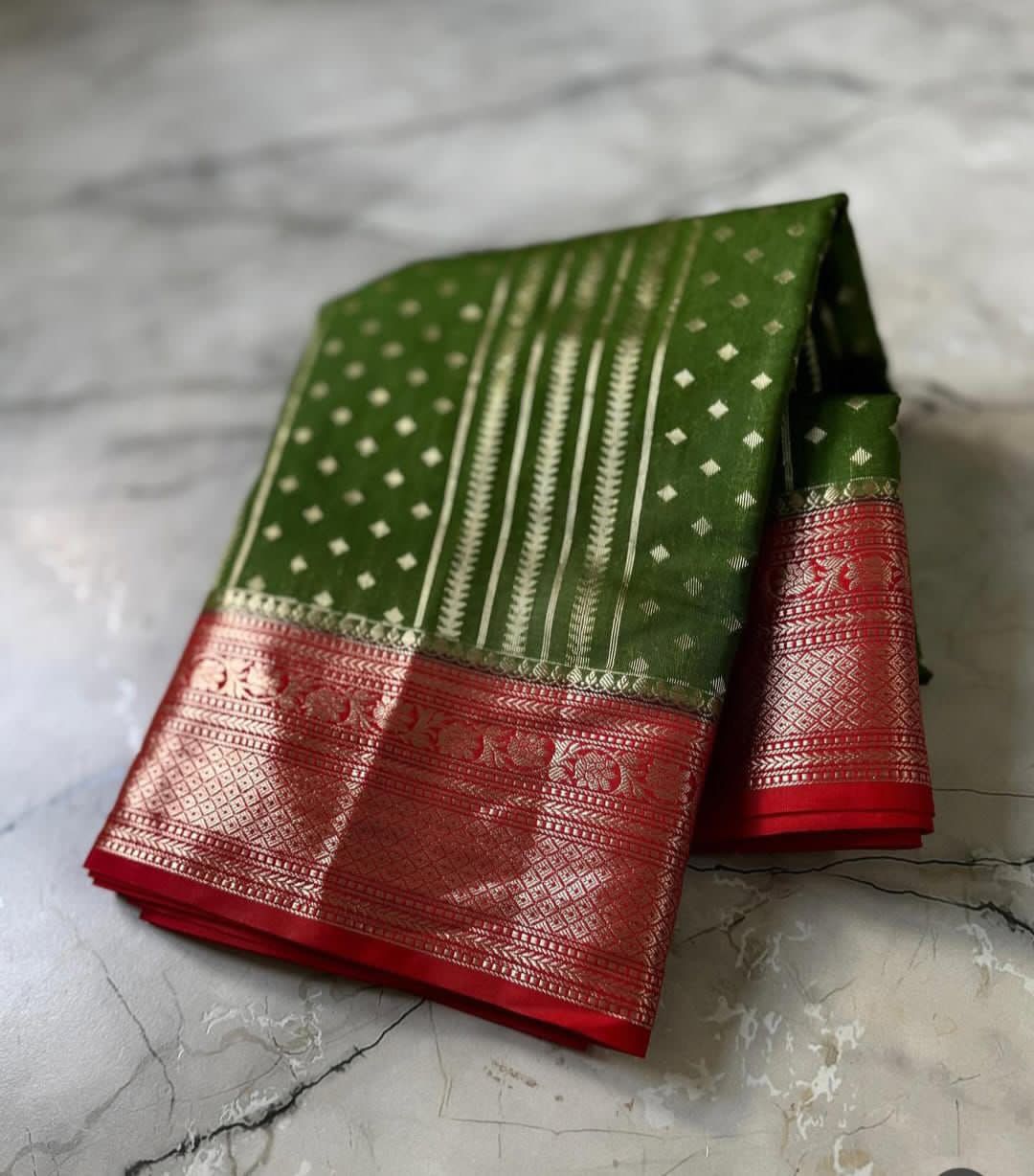 Olive Green saree with intricate patterns on a marble surface