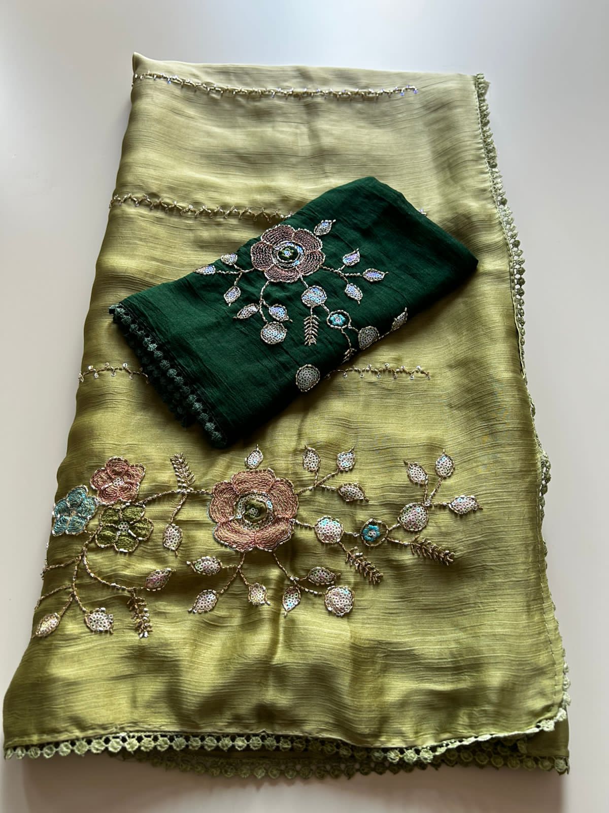 Olive Green embroidered fabric with a matching pouch on a light background