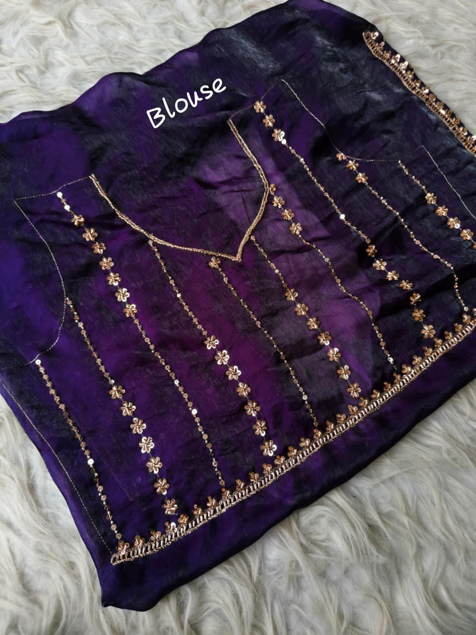 Purple blouse with gold embroidery on a fur surface