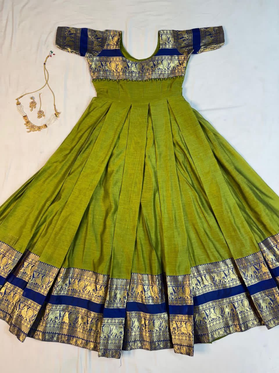 Parrot Green traditional dress with  gold accents on a white background