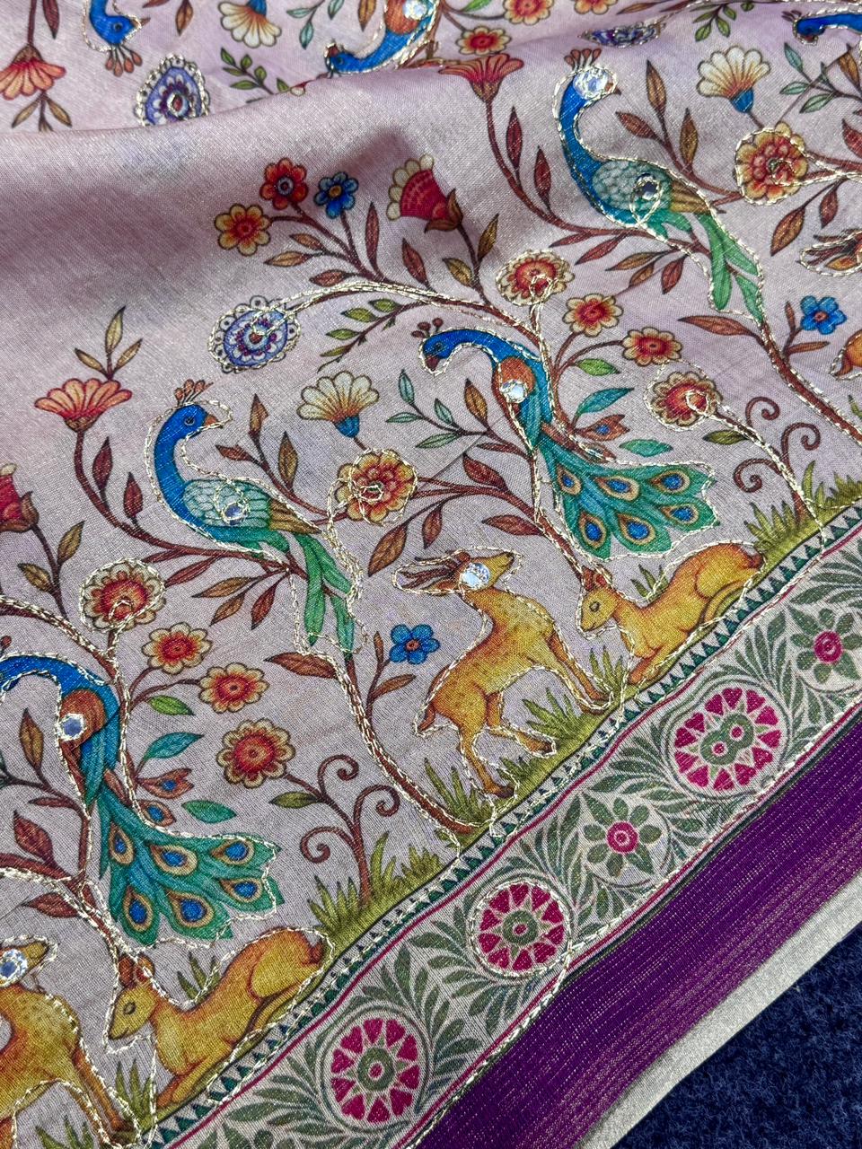 Blush pink fabric with peacocks, deer, and floral patterns on a pink background