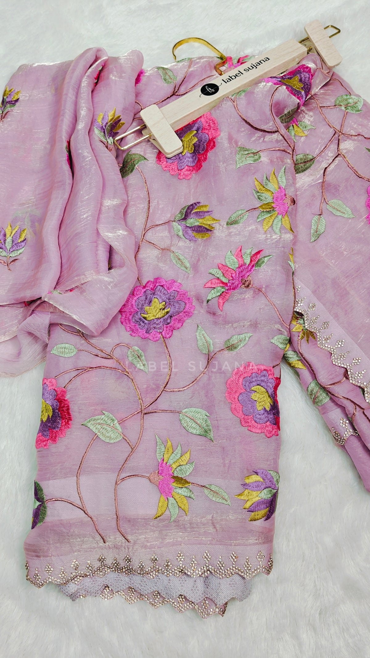 baby pink saree with colorful floral embroidery and a matching embroidered blouse