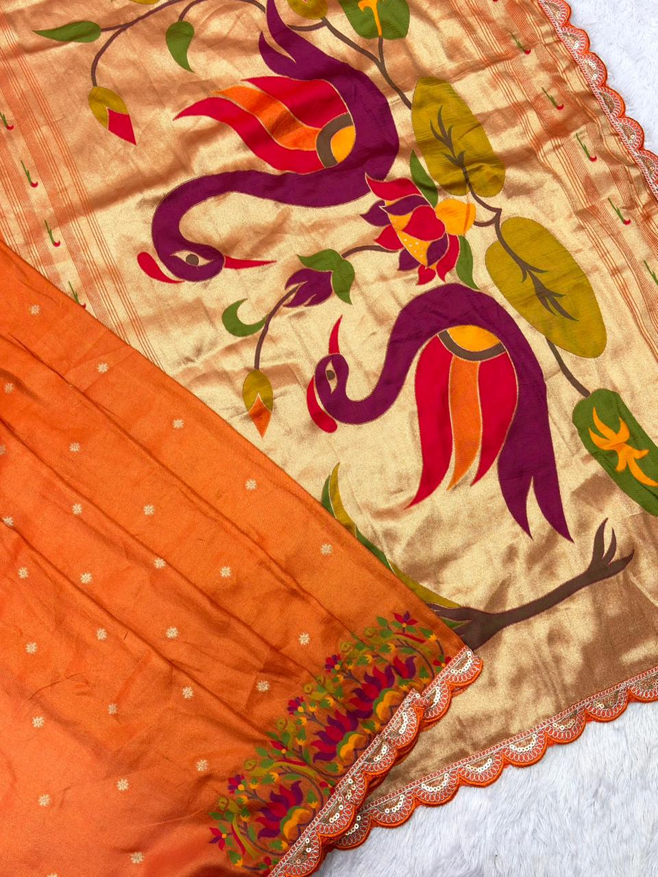 Orange Saree with colorful  design on a background