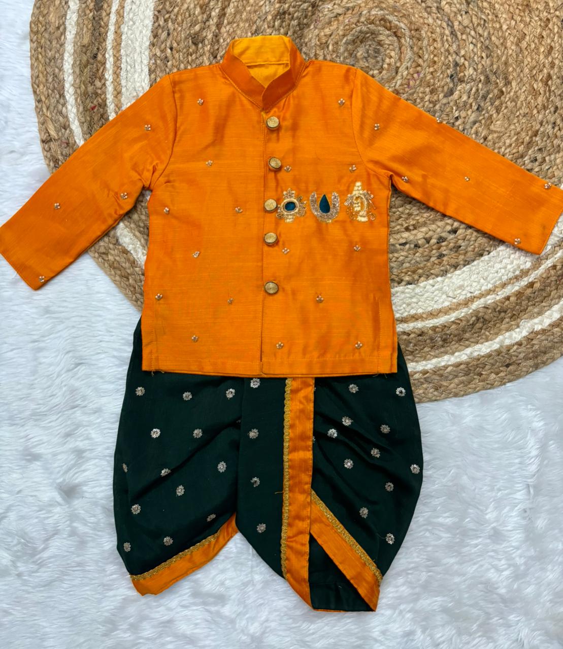 Traditional orange and bottle green outfit with intricate designs