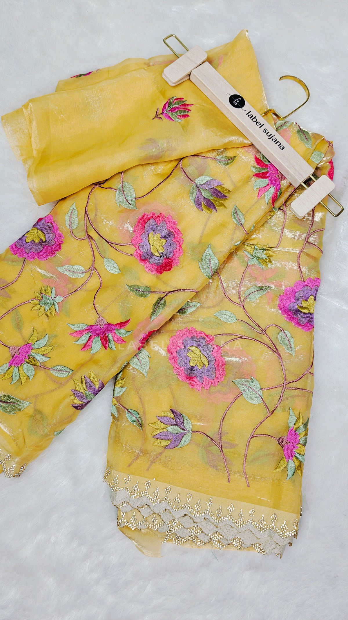 A yellow embroidered saree with matching blouse 