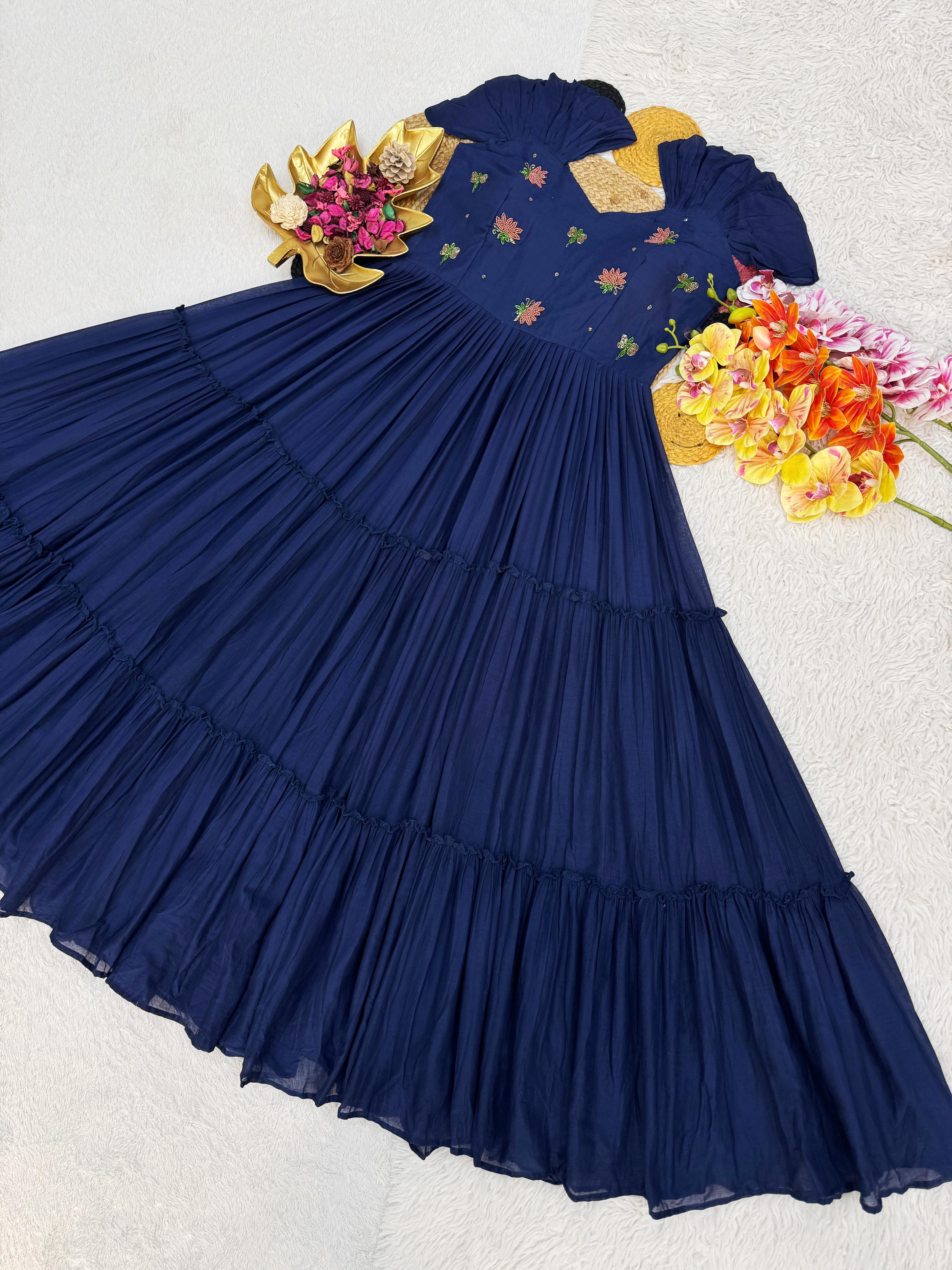 Navy blue dress with floral patterns and accessories on a light gray background