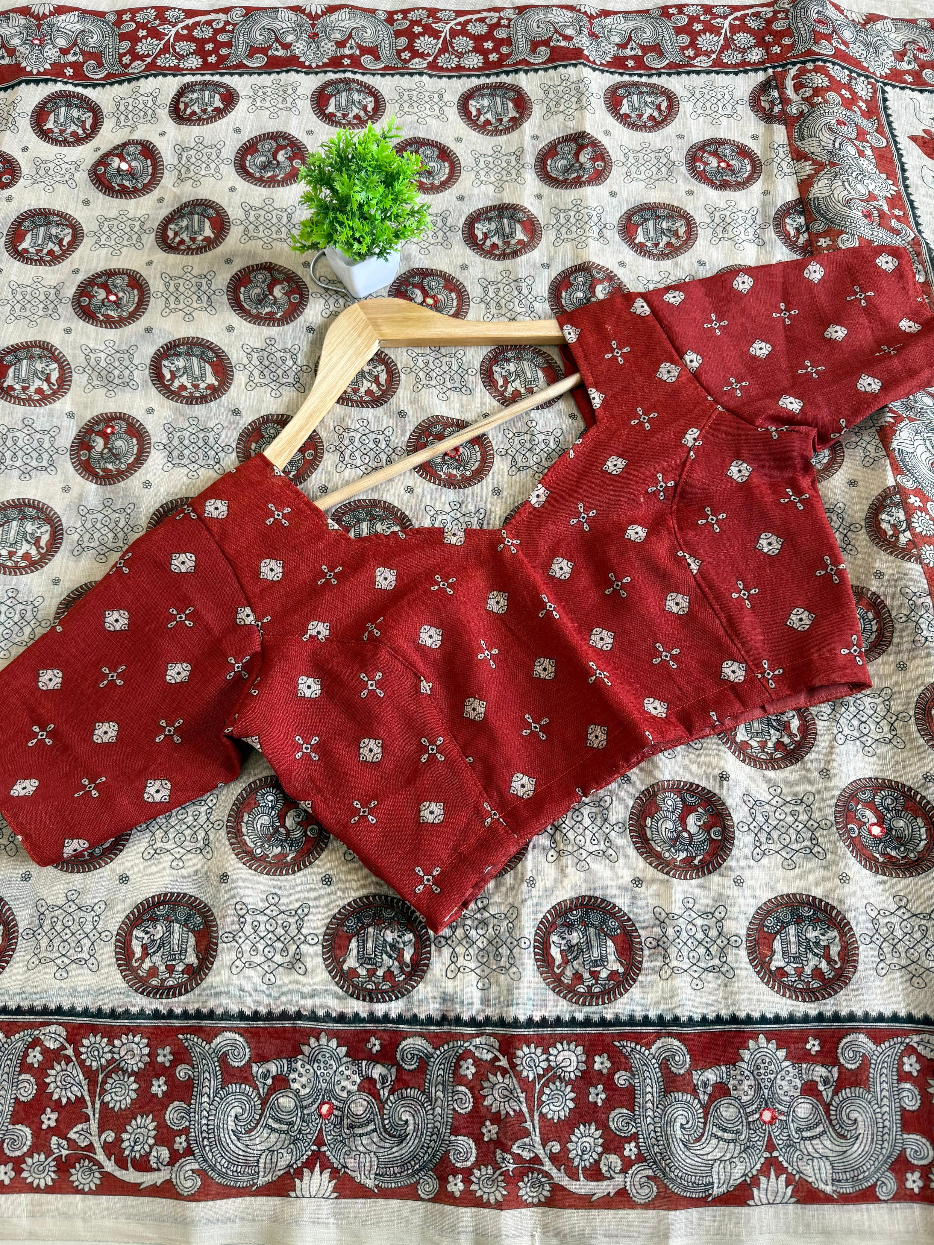 Red patterned blouse on a hanger with a Beige traditional fabric background