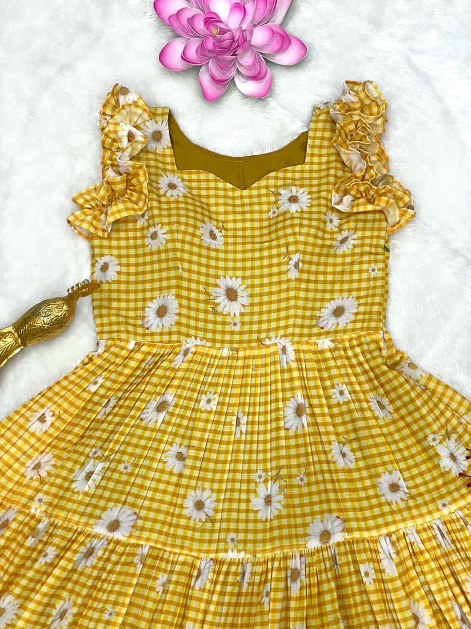 Yellow checkered dress with floral details on a white background