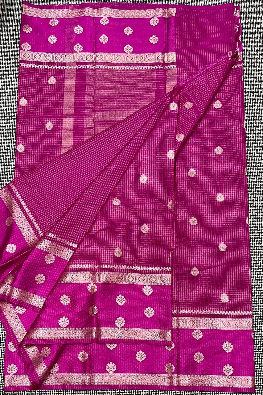 Pink saree with white patterns on a texture surface