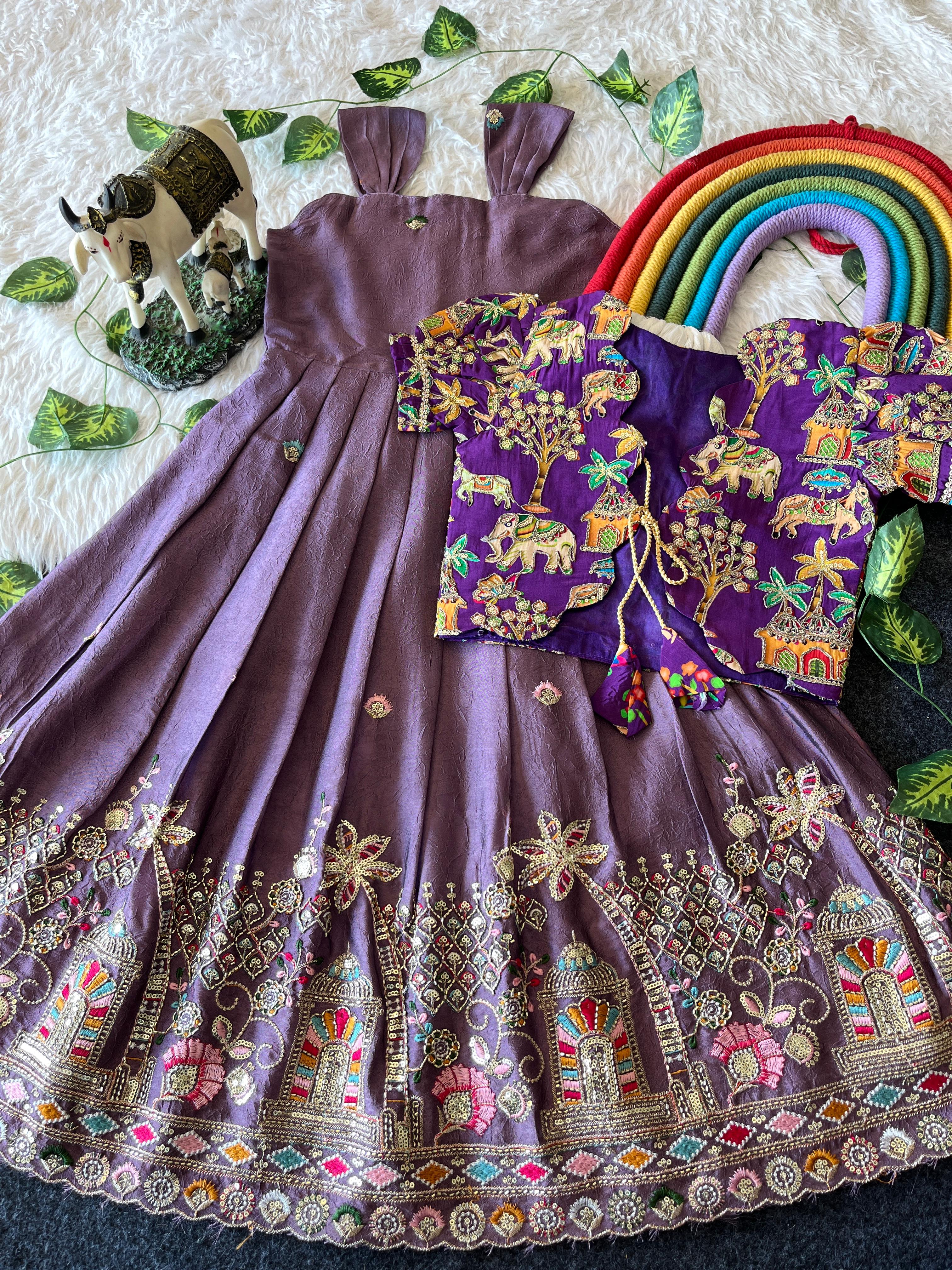 Traditional Lavender embroidered outfit with a colorful blouse and skirt on a textured surface.