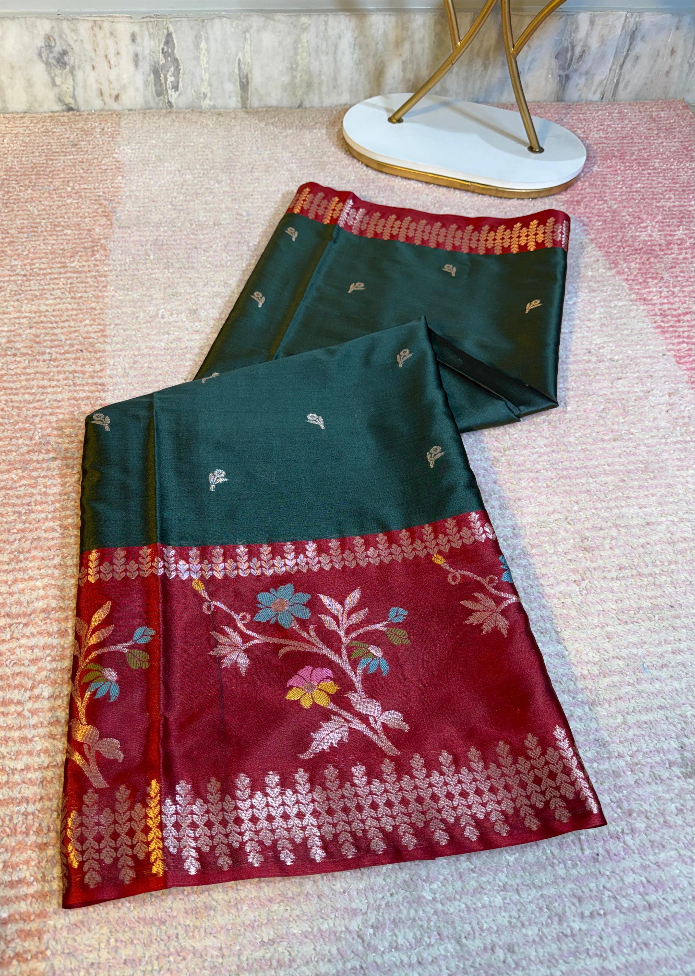 Dark Green and red saree with floral patterns on a textured surface
