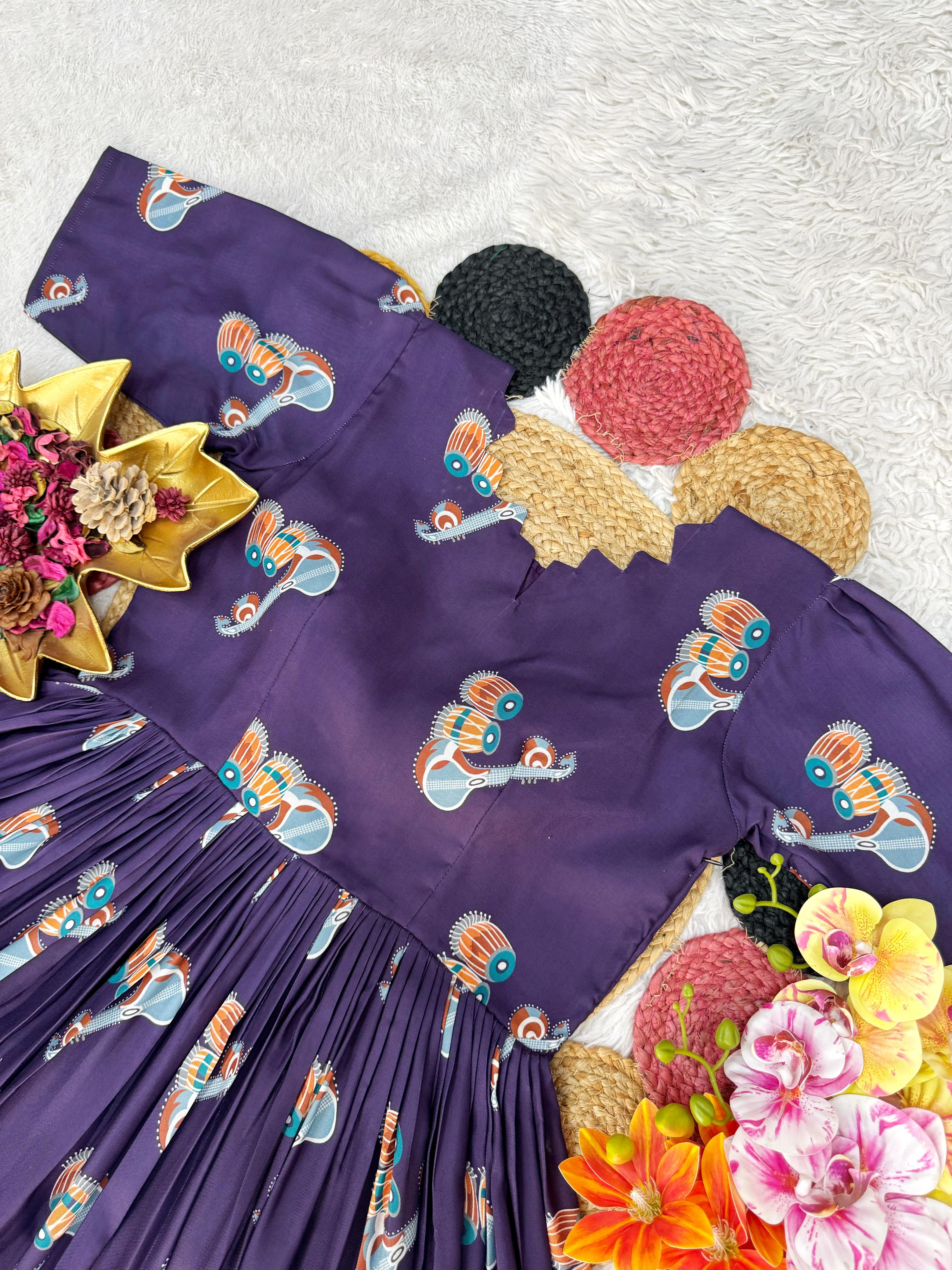 Purple dress with fish pattern on a texture surface surrounded by flowers and pom-poms.