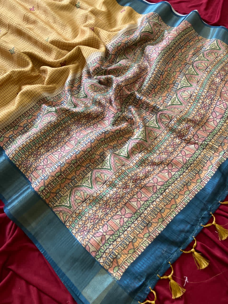 Colorful Mustard Yellow patterned fabric with tassels on a background