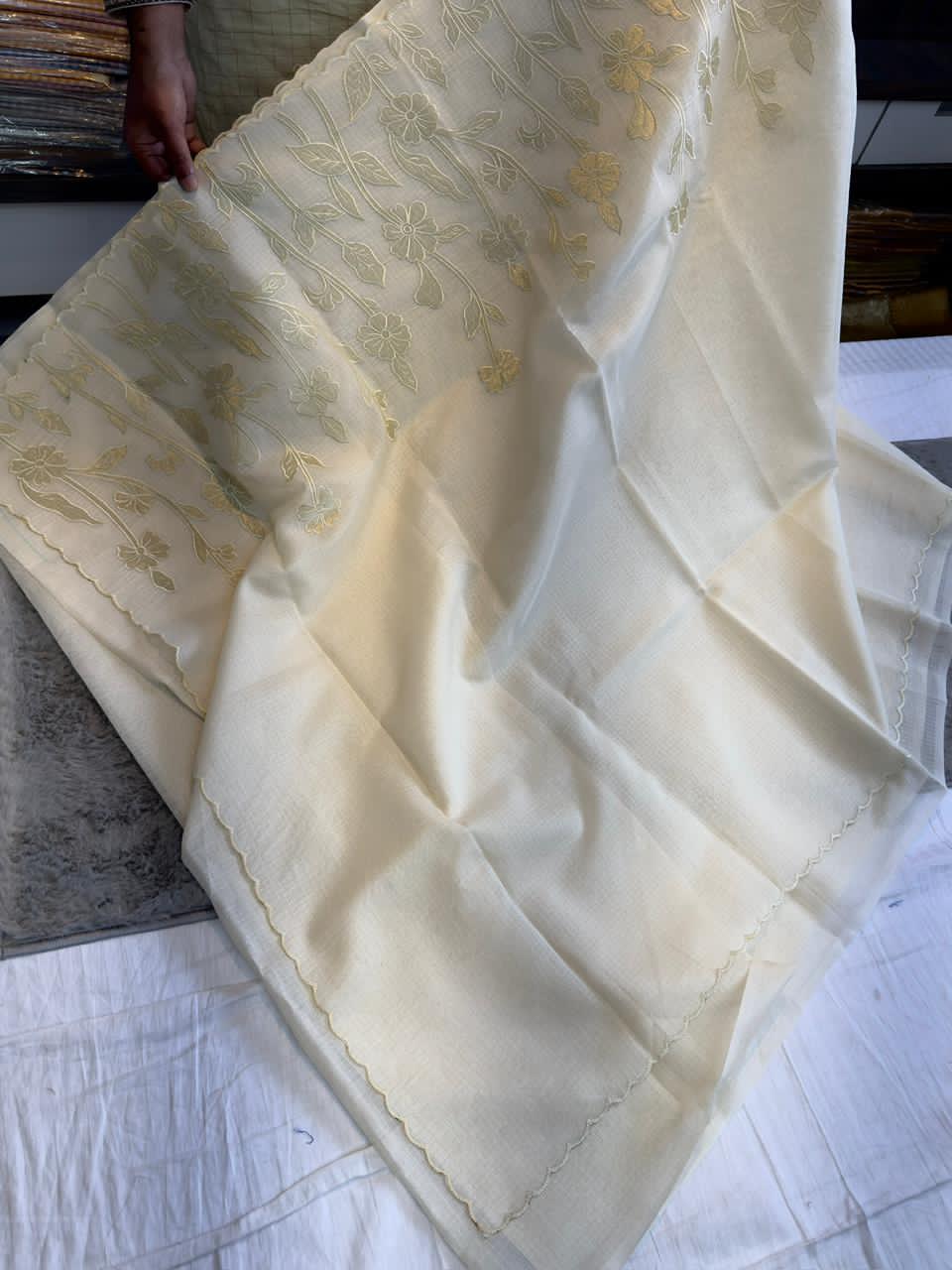 White fabric with gold embroidery patterns 