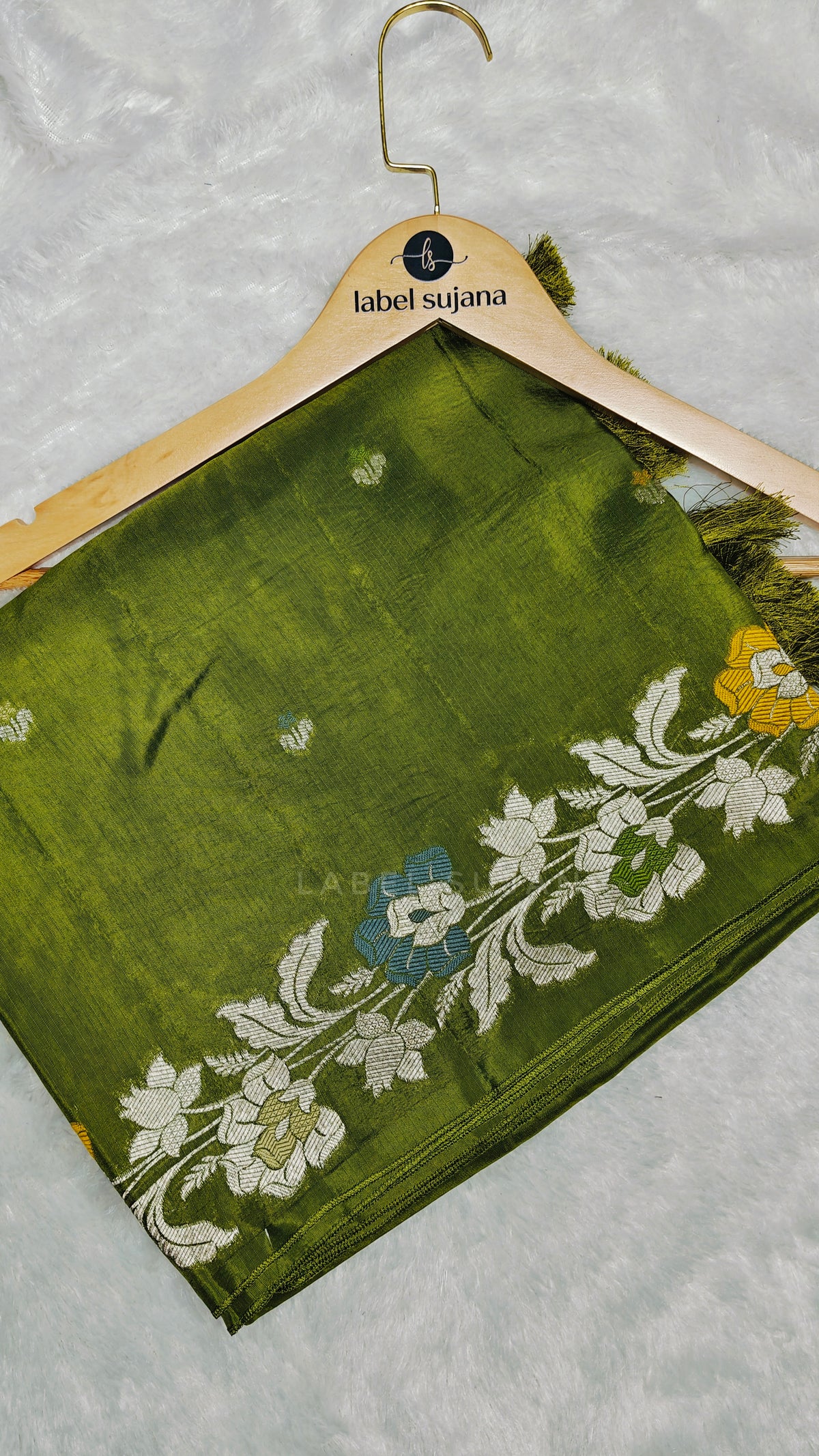 An olive green silk saree