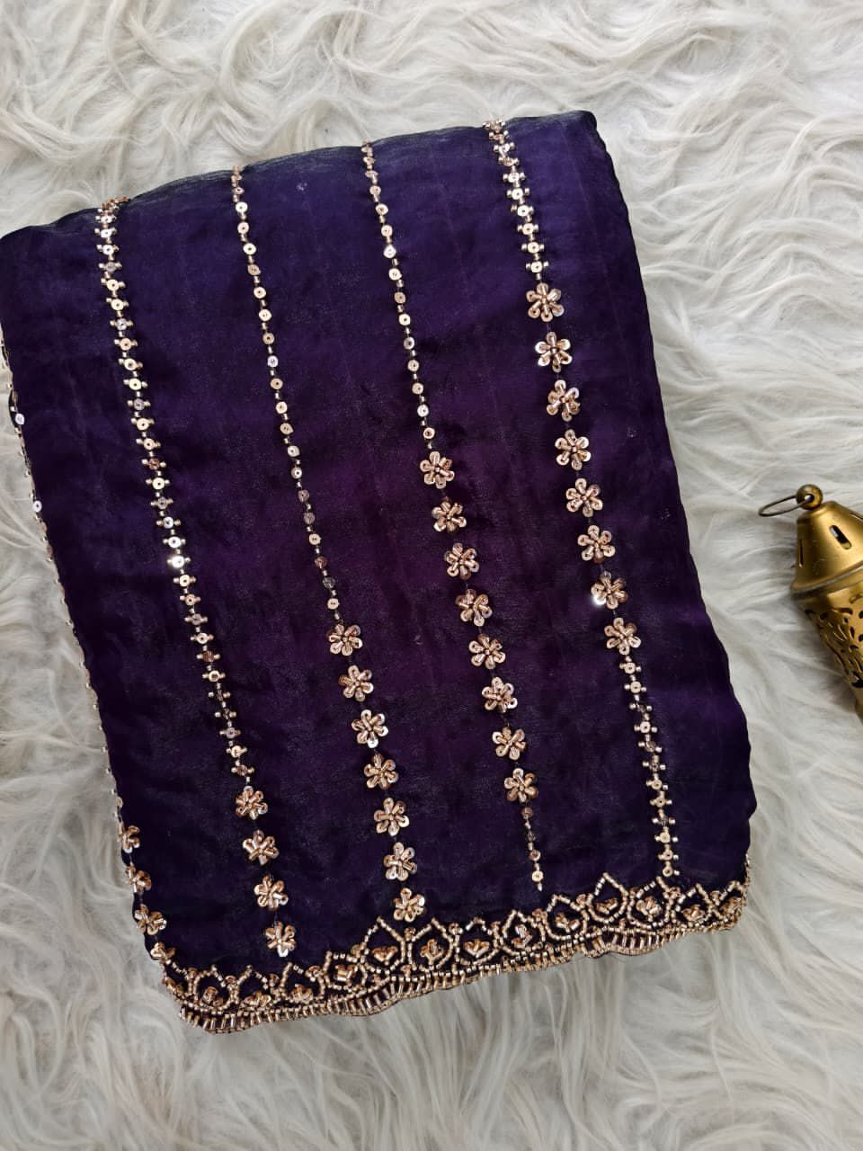 Purple fabric with gold embroidery on a texture background