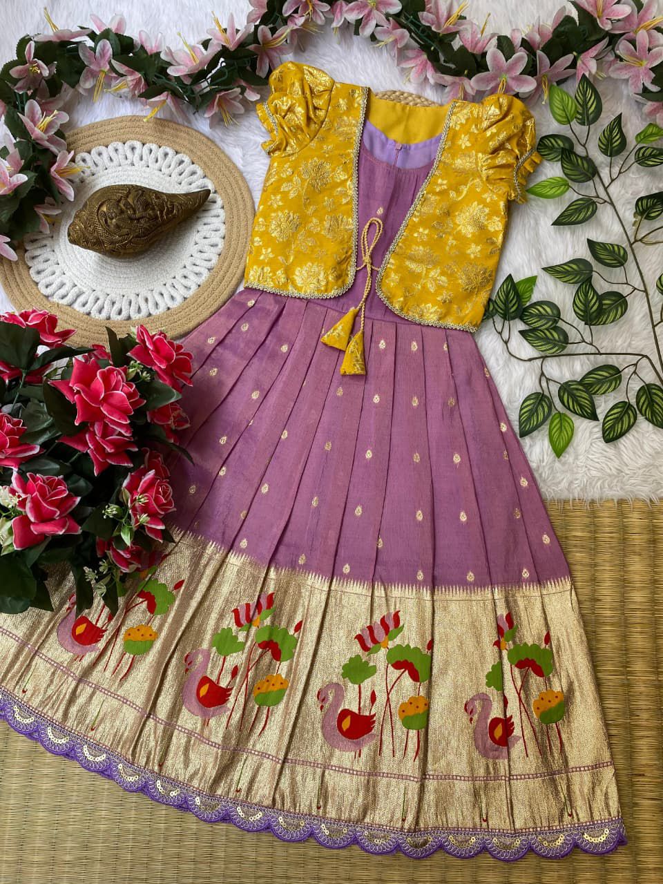 Lavender embroidered skirt on a decorative background with flowers and leaves.