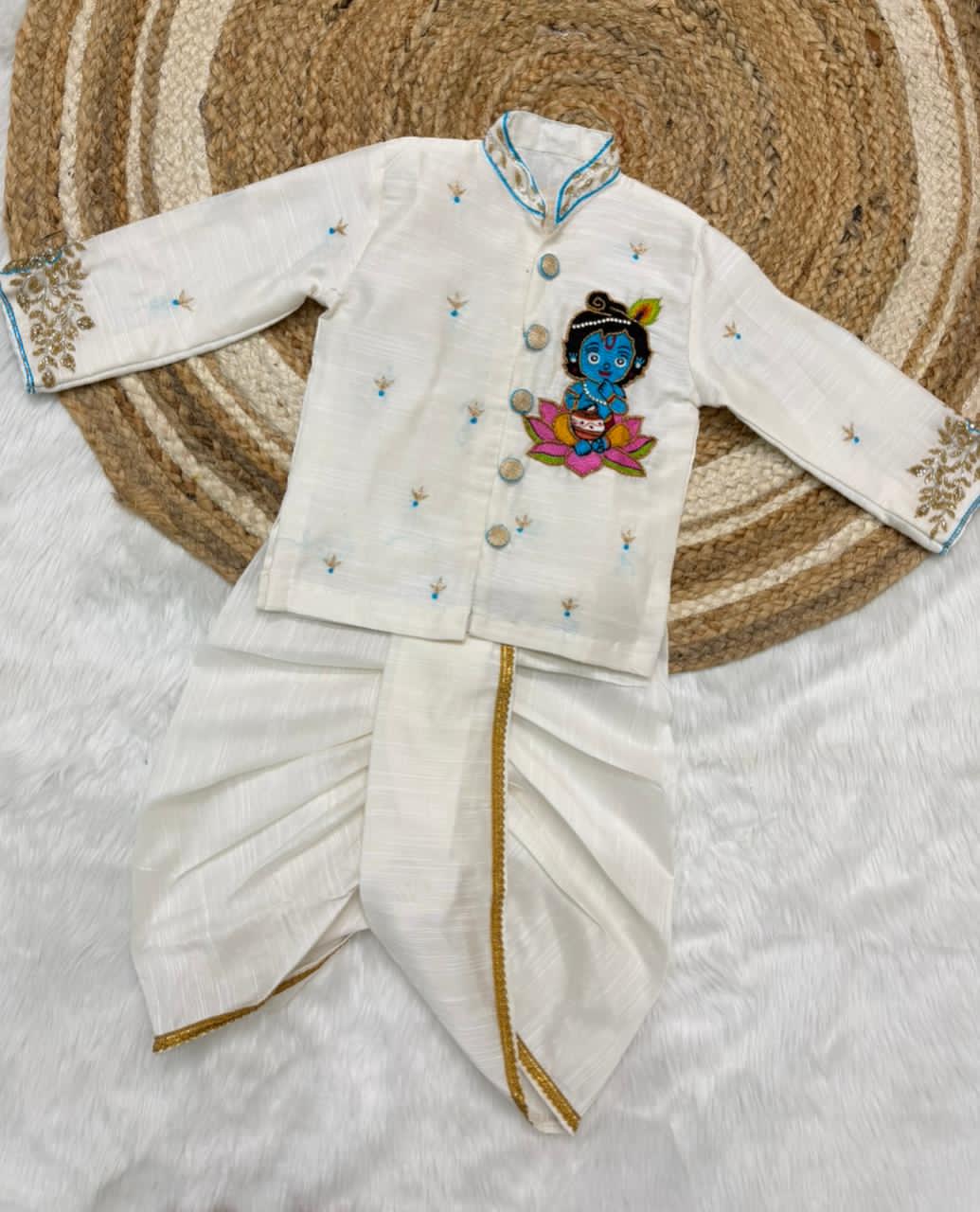 White embroidered traditional outfit with a colorful design on a textured surface