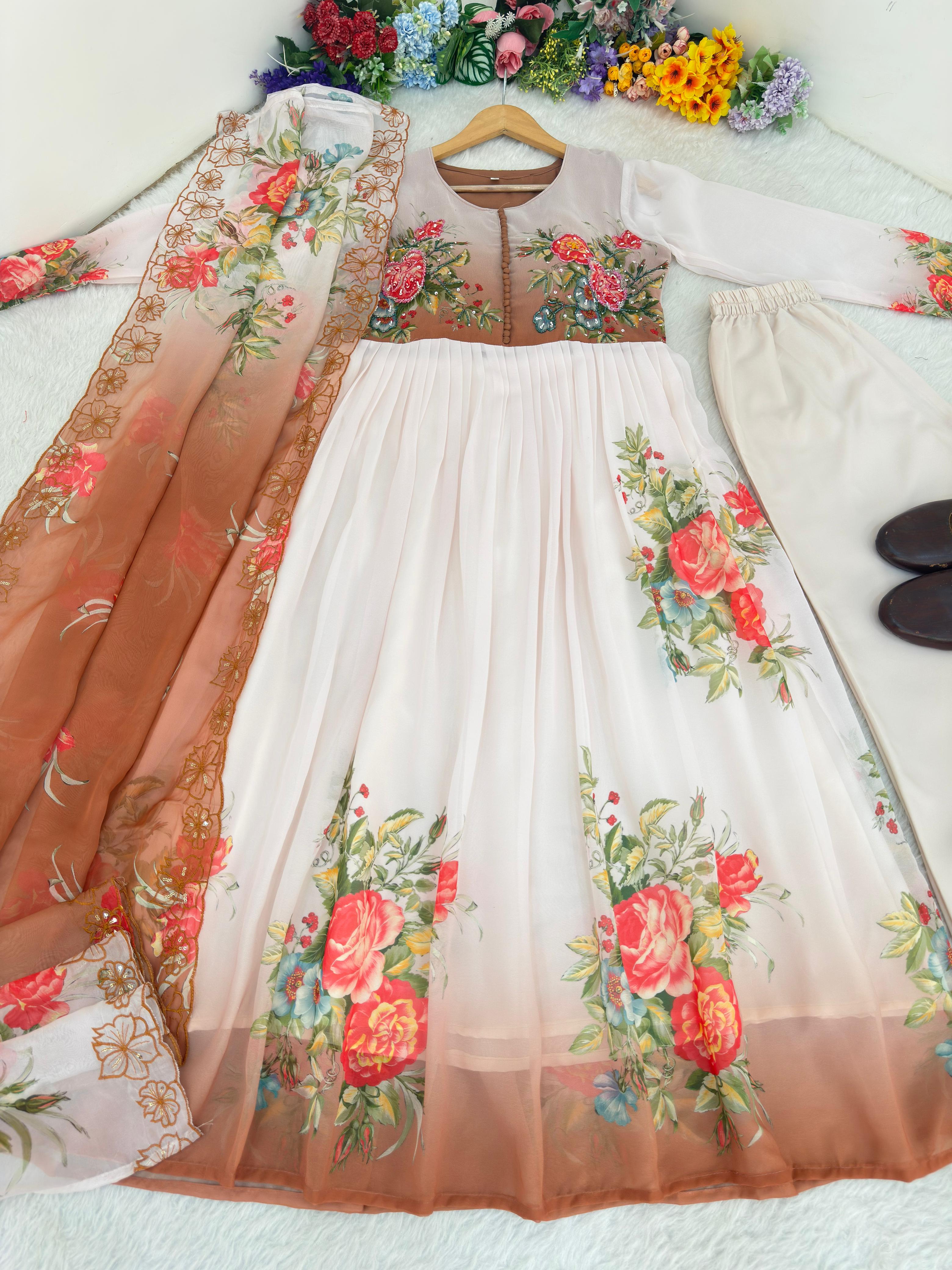 Floral white and brown embroidered dress with sheer overlay on a white surface