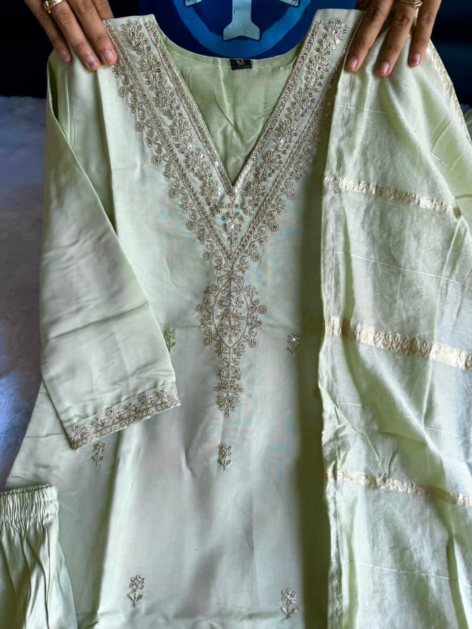 Light green traditional outfit with intricate embroidered work 