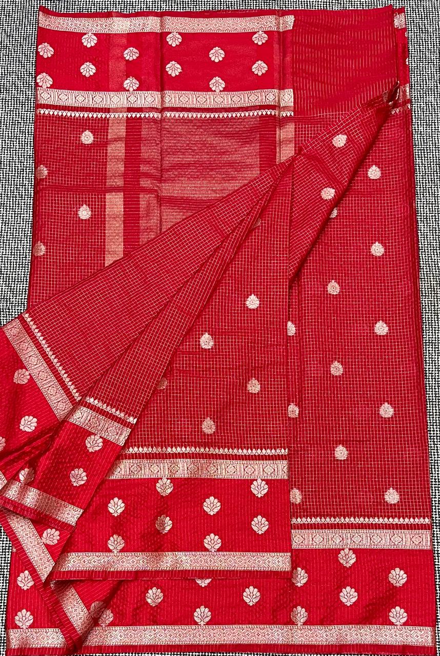 Red saree with white patterns on a checkered background