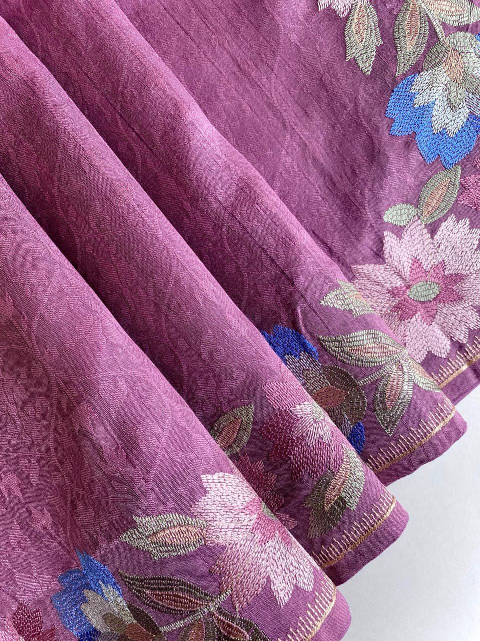 Purple fabric with floral embroidery on a background