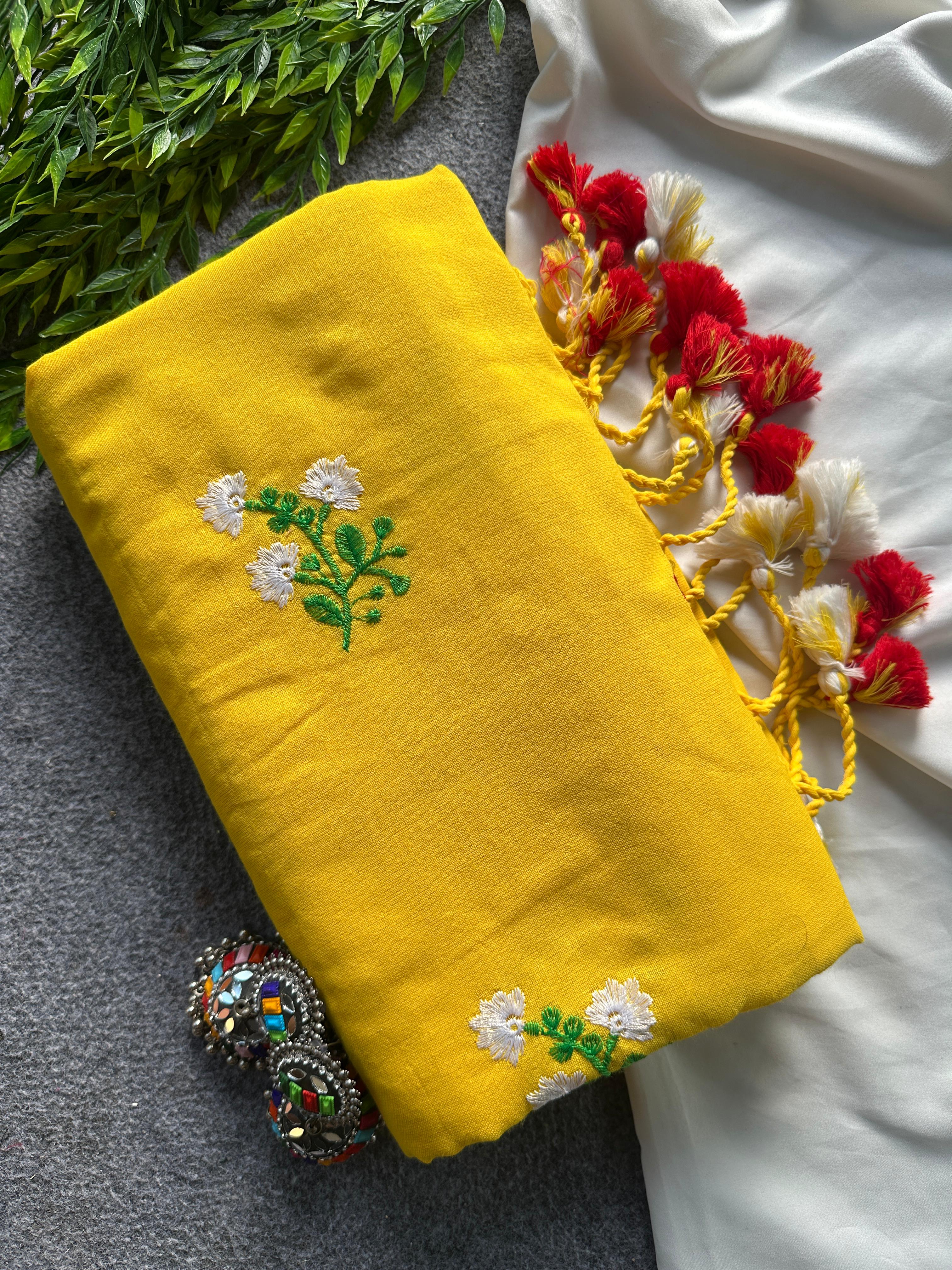 Yellow fabric with floral embroidery and tassels