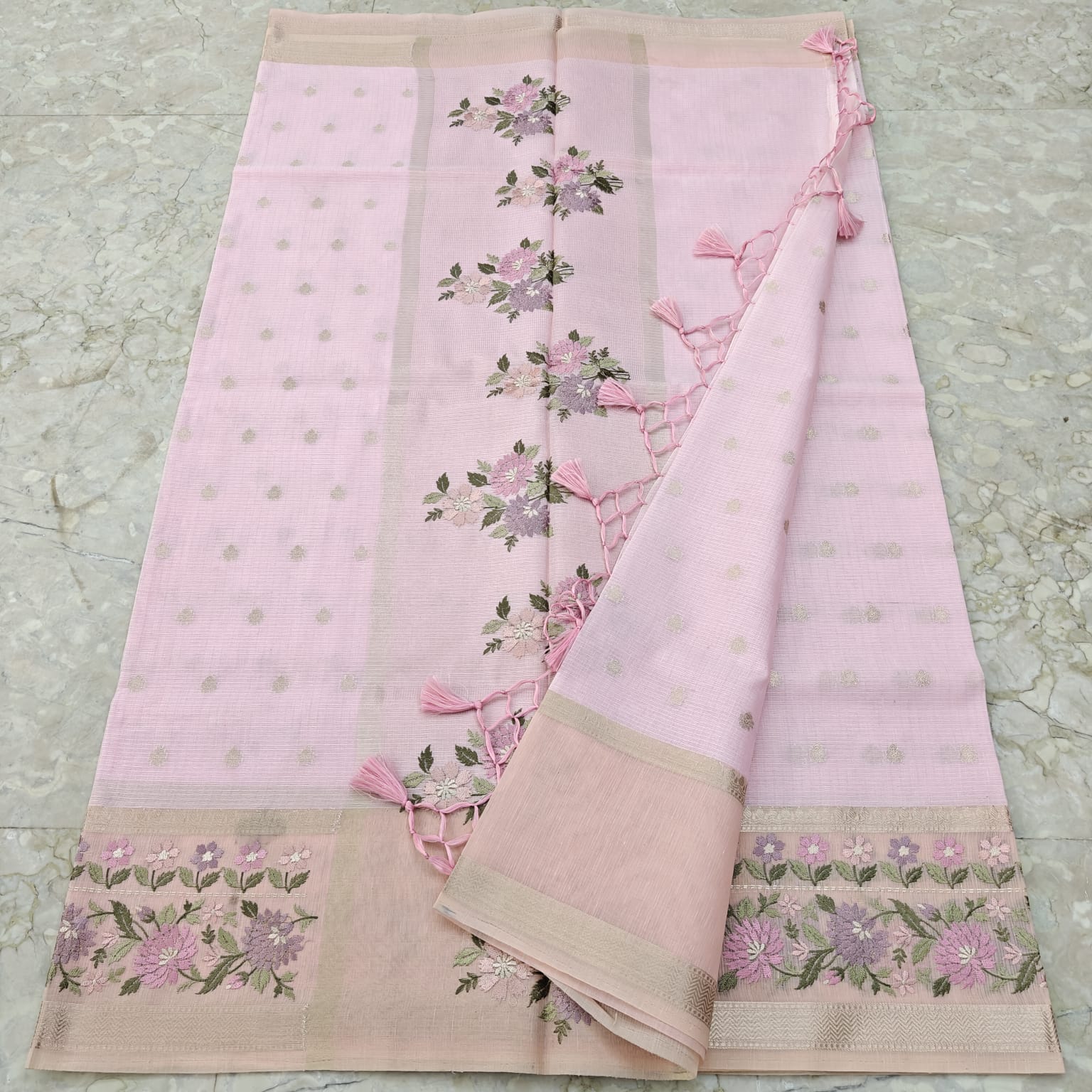 Light Pink saree with floral patterns on a textured surface
