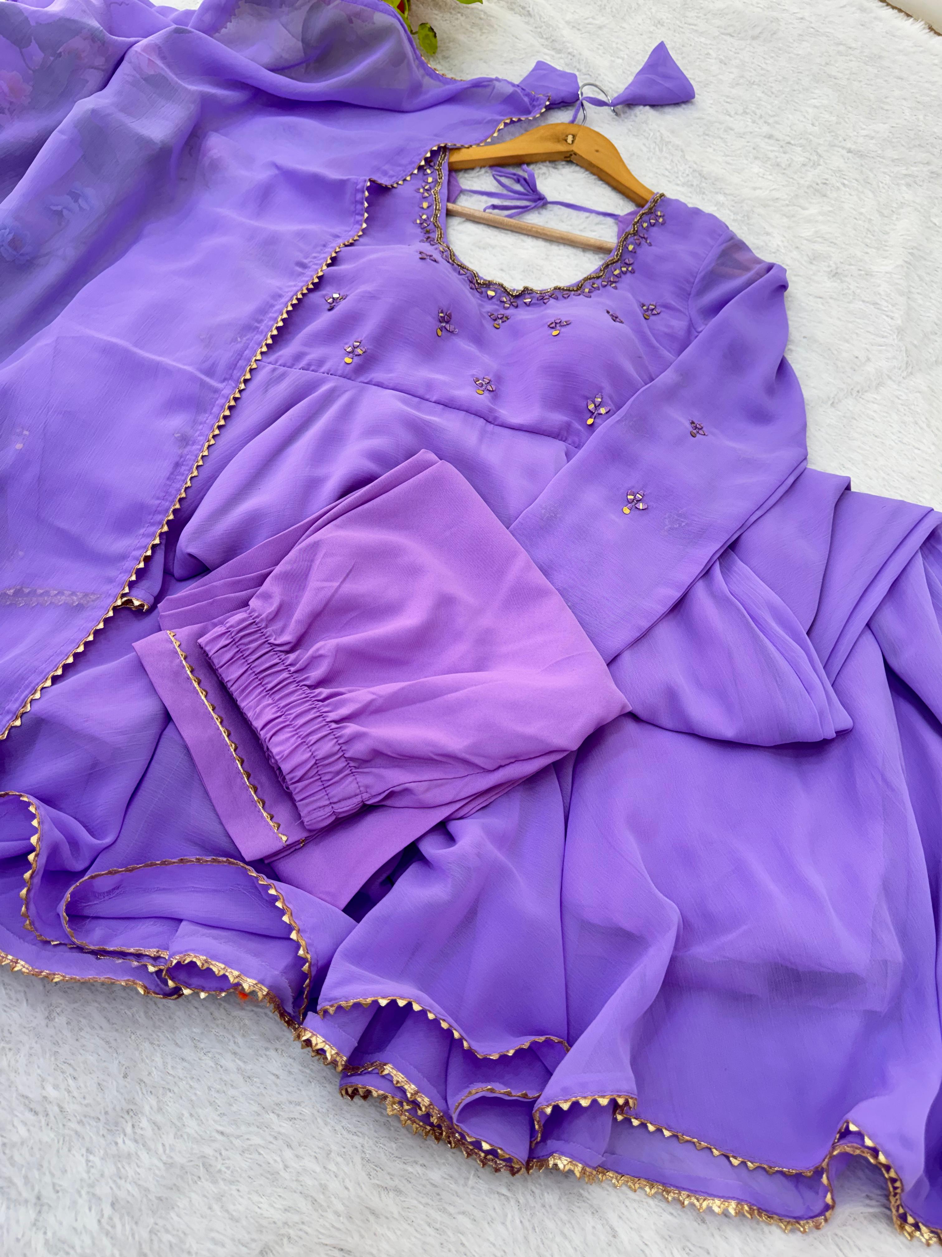 Purple traditional outfit with gold details on a light gray background