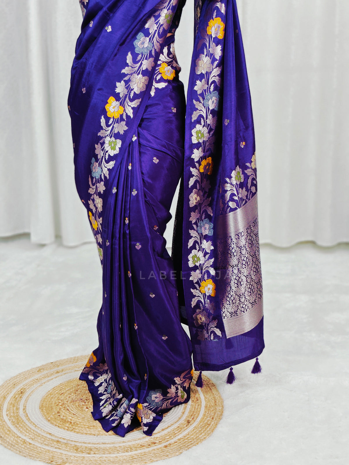 A woman wearing a purple silk saree