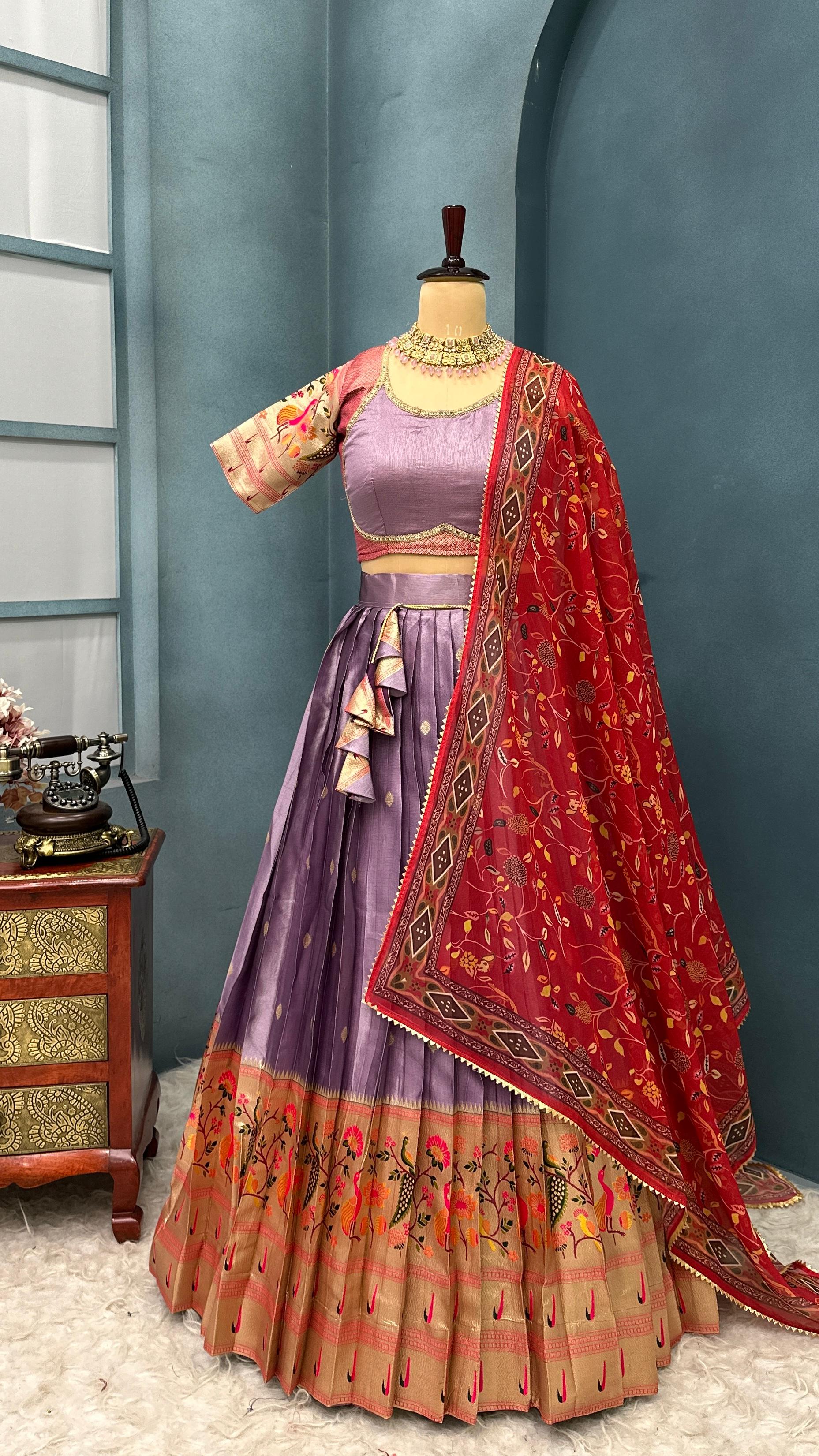 Traditional Indian outfit with a Lavender with red dupatta on a mannequin against a blue wall.