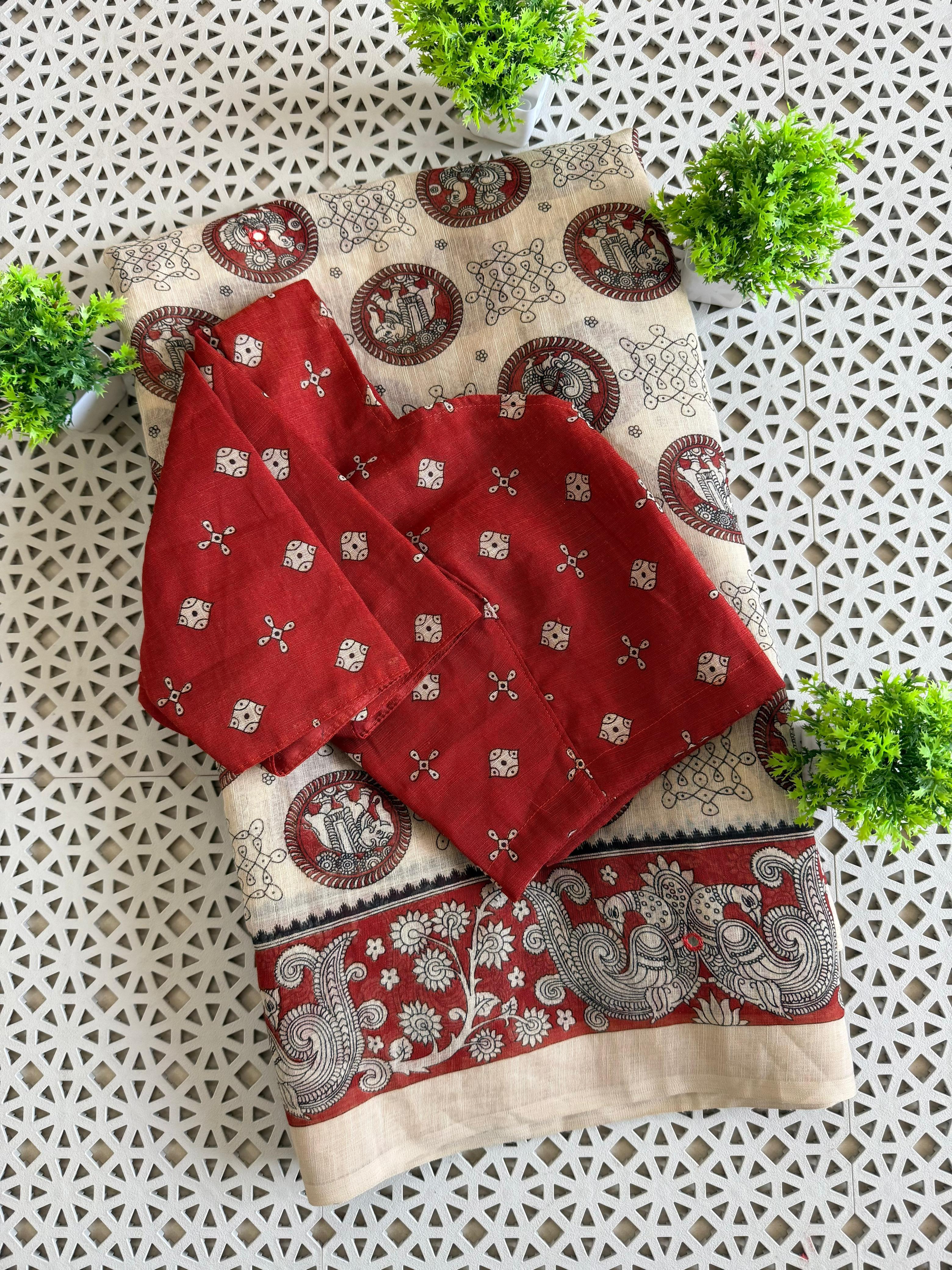 Red and Beige patterned towels on a textured surface with green plants.