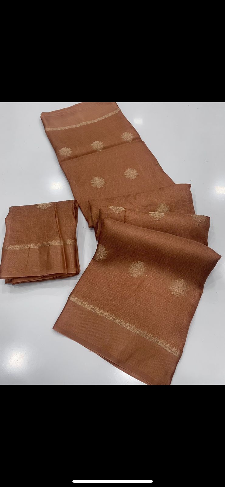 Brown saree with gold patterns on a white background