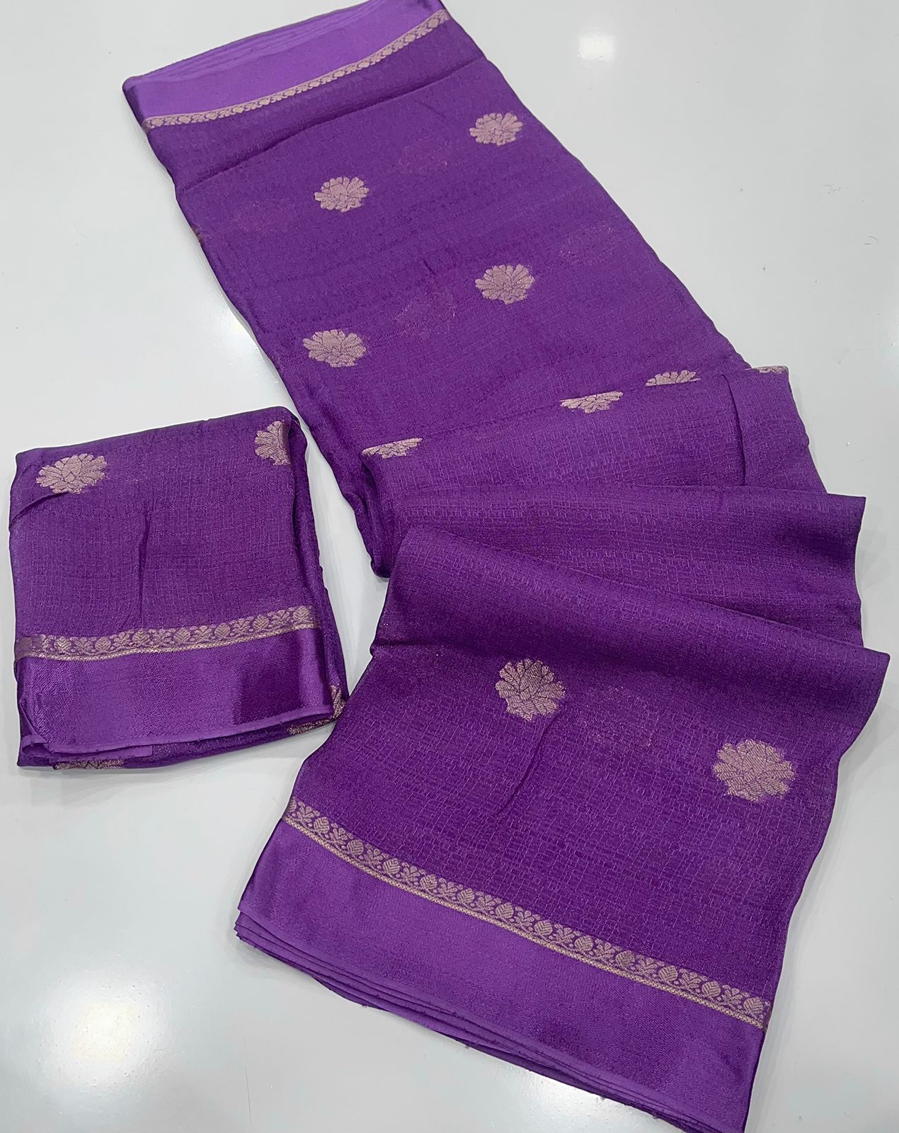 Lavender fabric with gold embroidery on a white background