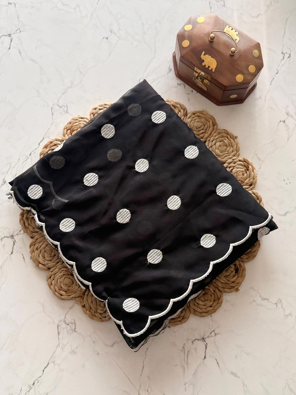 Black with white dots on a textured surface