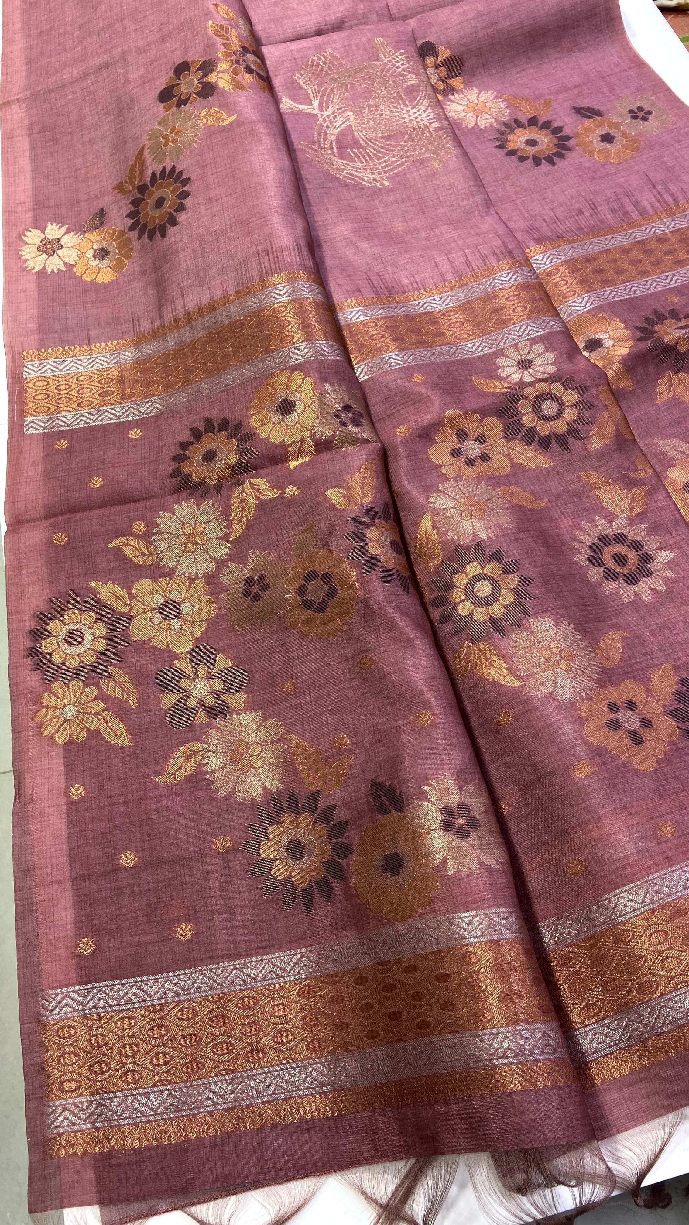 Copper fabric with floral patterns and gold accents on a white background