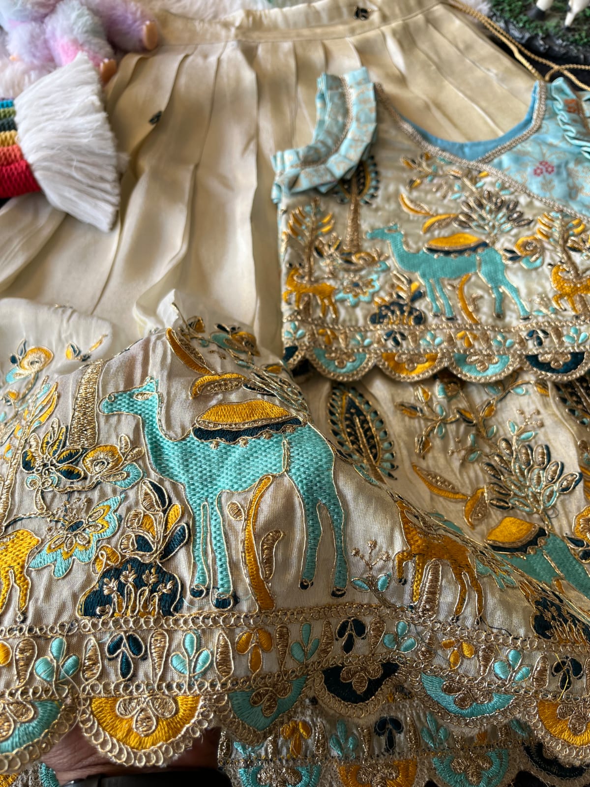 Beige intricate embroiderey fabric with animals and patterns