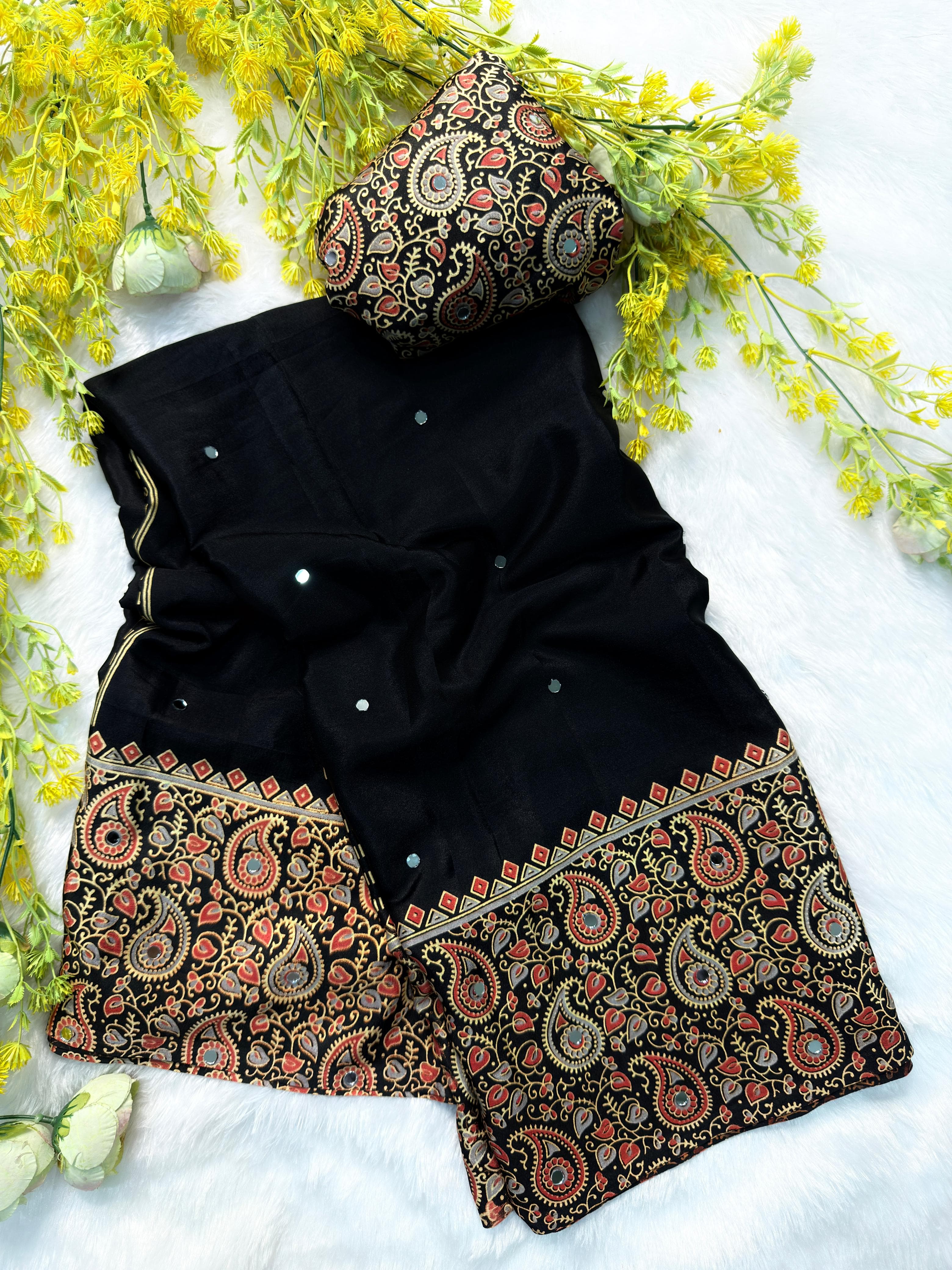 Black saree with patterned border on a white background with yellow flowers